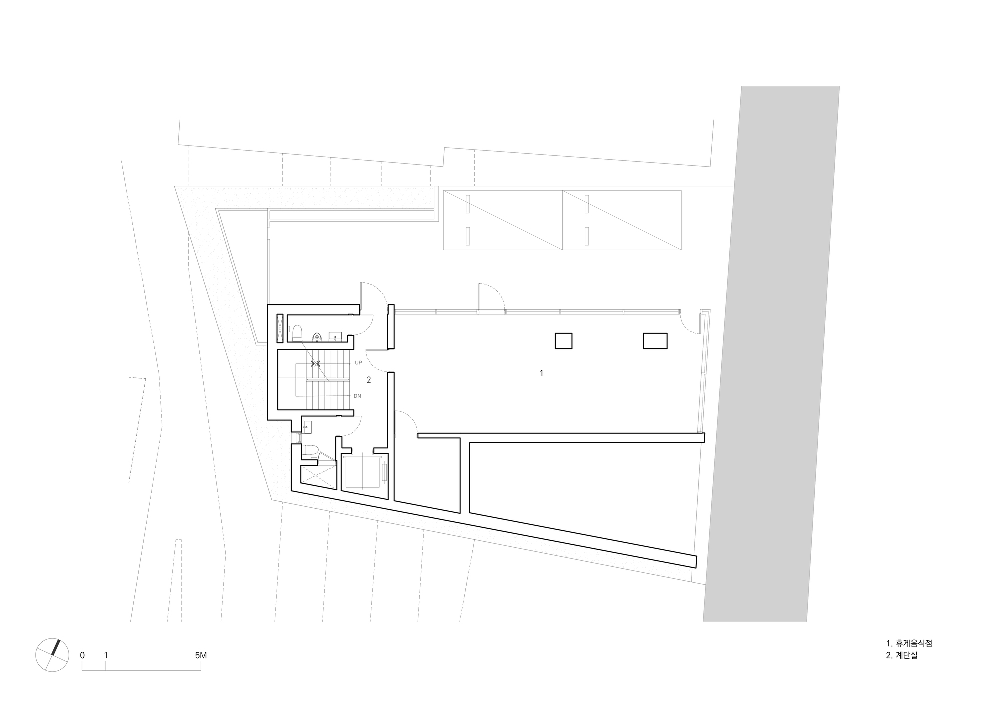 Floor plan drawing showing the main level with open interior and diagonal street edge