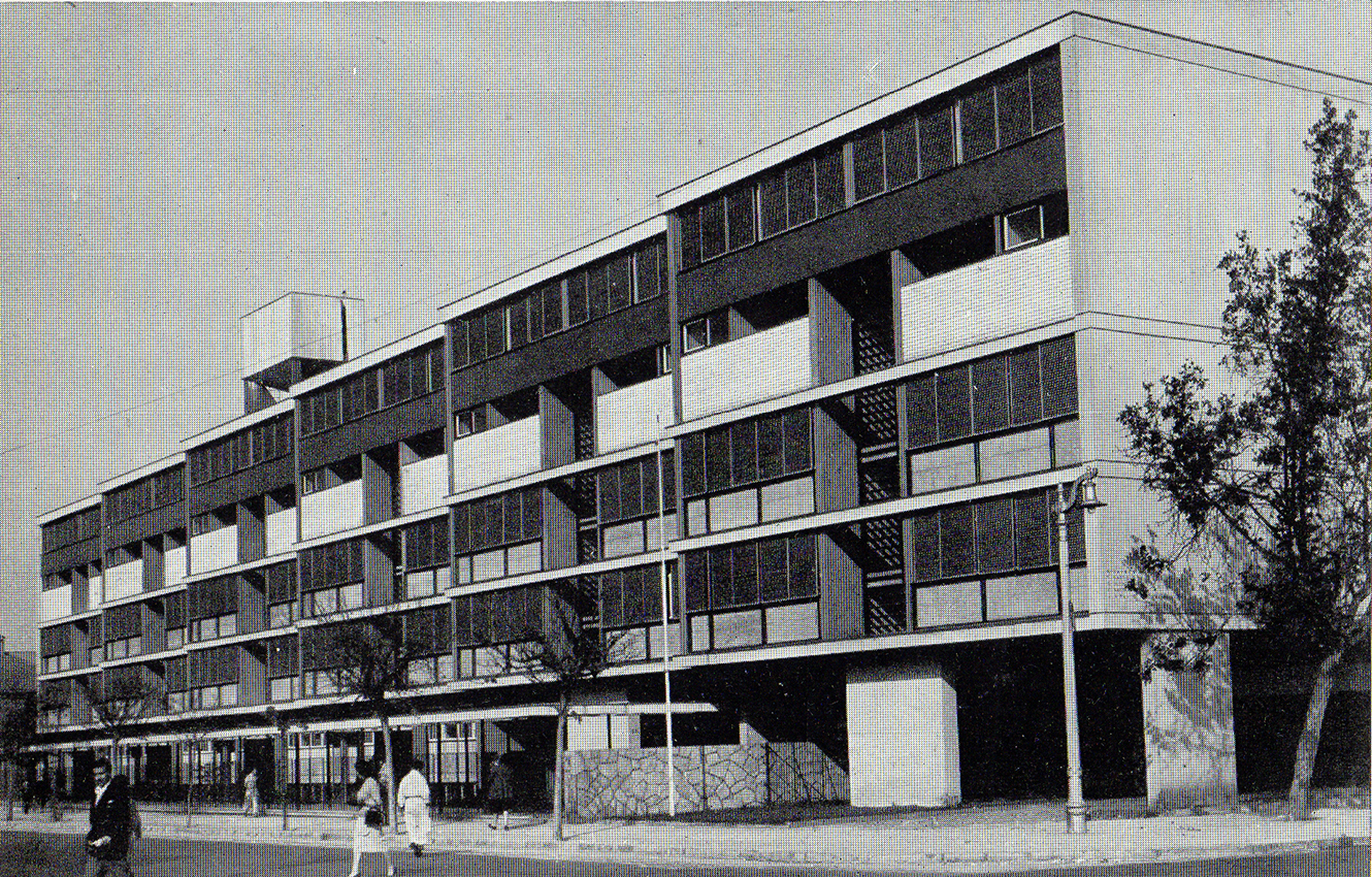 Elevation of the residential block with checkerboard facade pattern and pilotis at ground level beside young trees