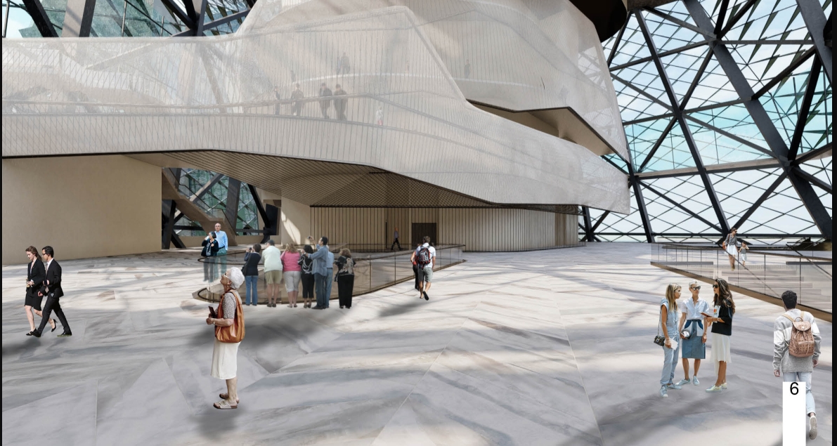 Large atrium with a pale folded volume suspended under a triangulated steel and glass roof, visitors gathered on the stone floor. Image: Azadeh K