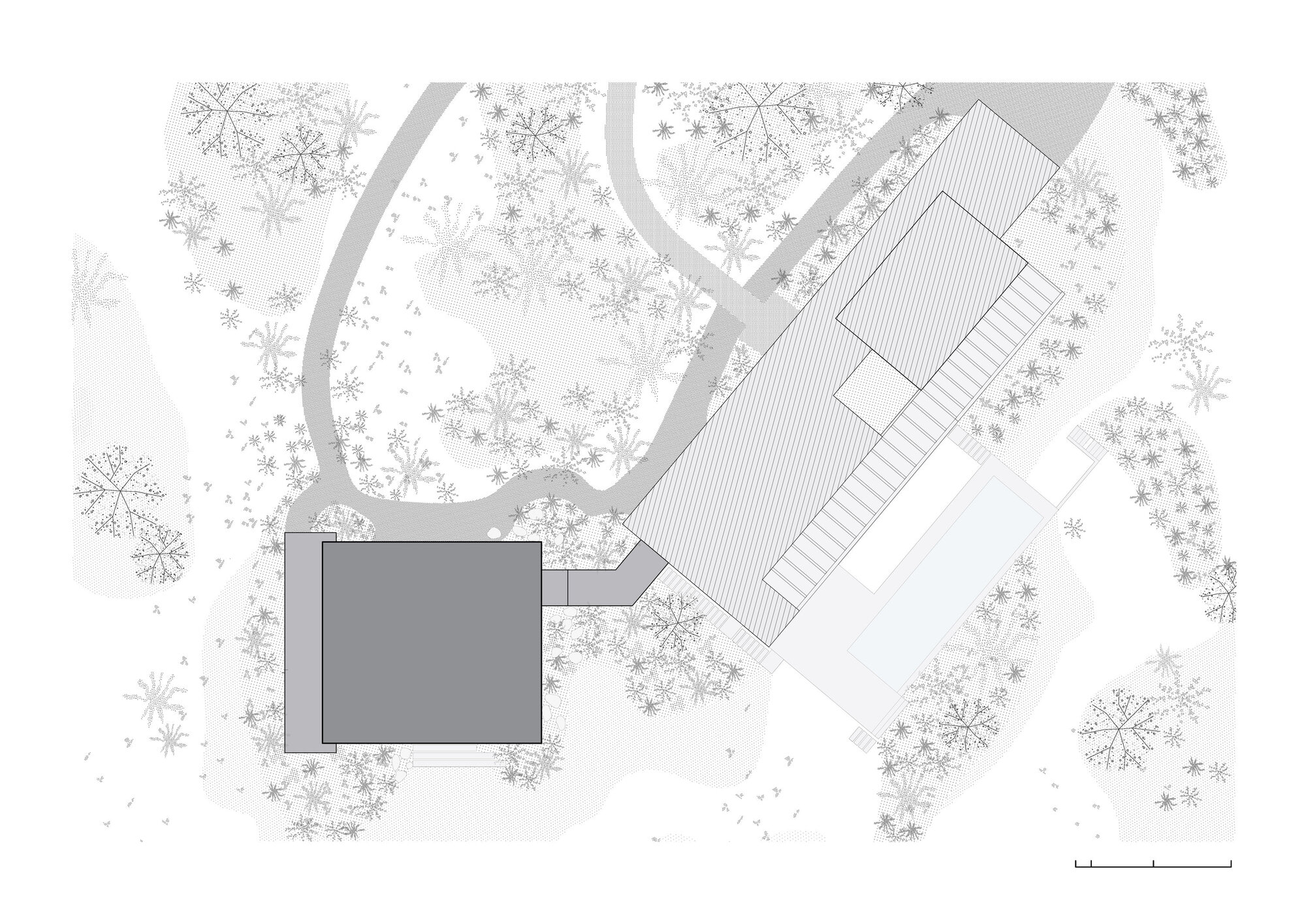 Site plan drawing showing two volumes connected by a covered walkway among dense tree canopy