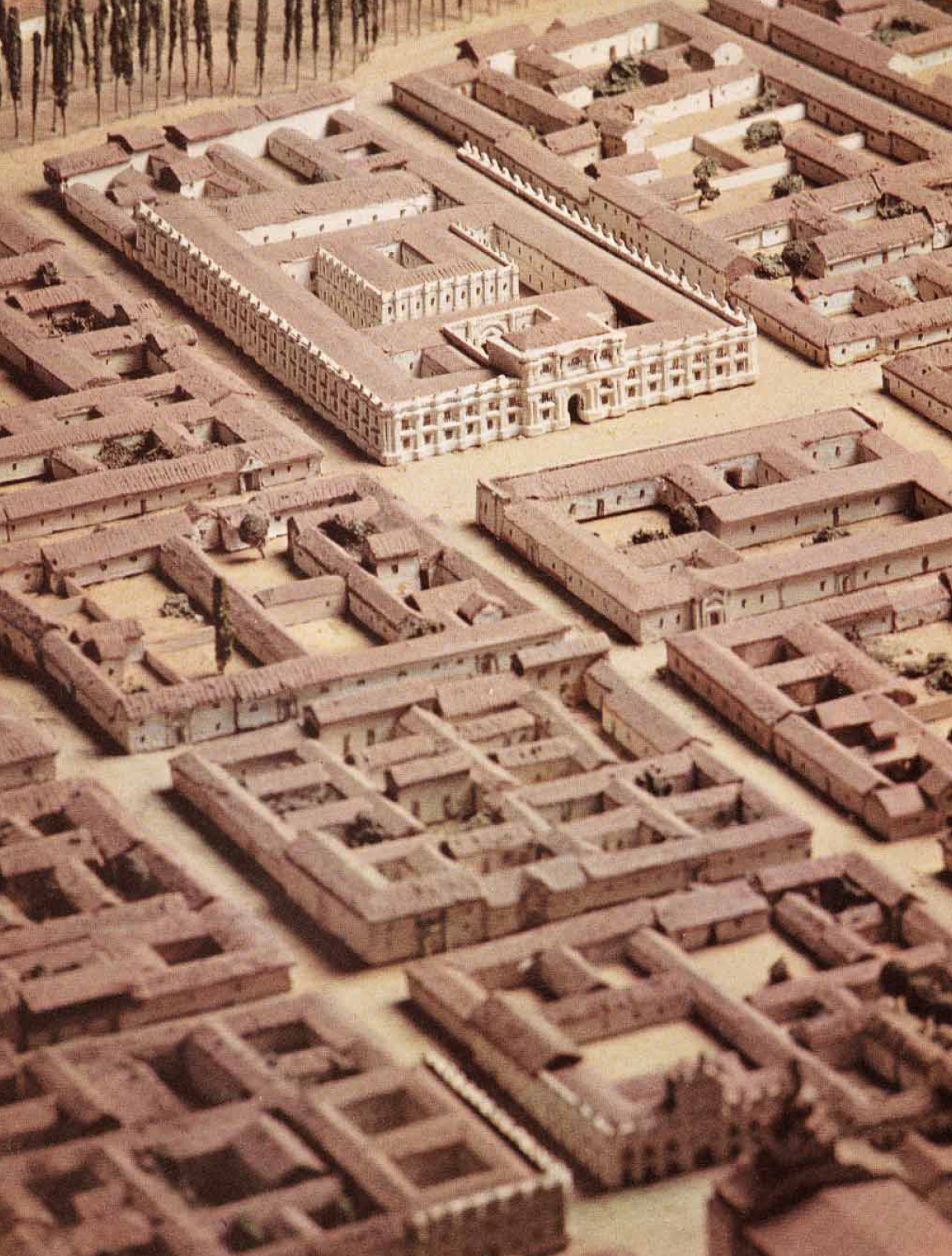 Physical model showing a multi-courtyard complex with perimeter buildings surrounding open quadrangles