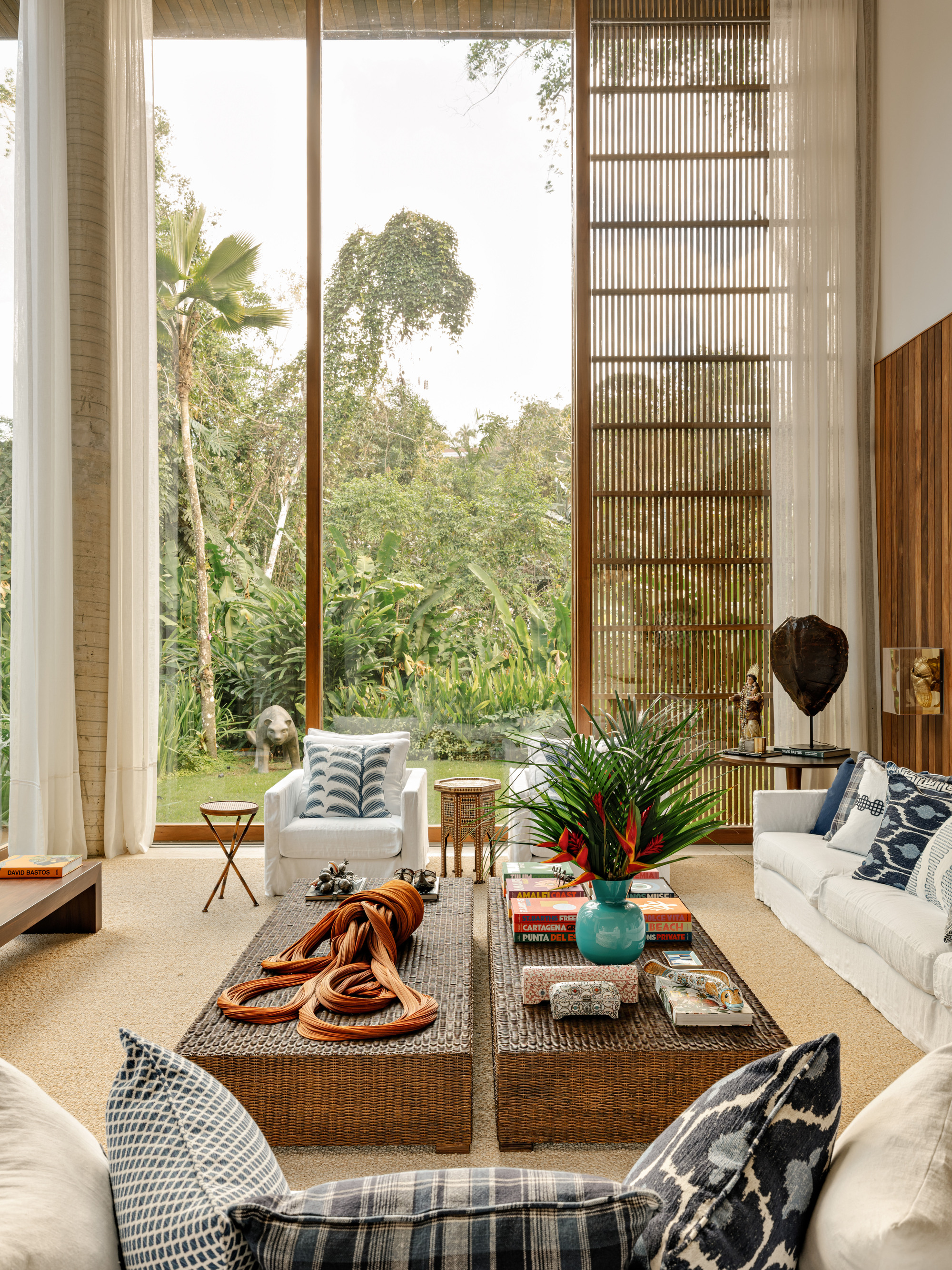 Double-height living room with full-height windows, timber brise-soleil screen and garden view