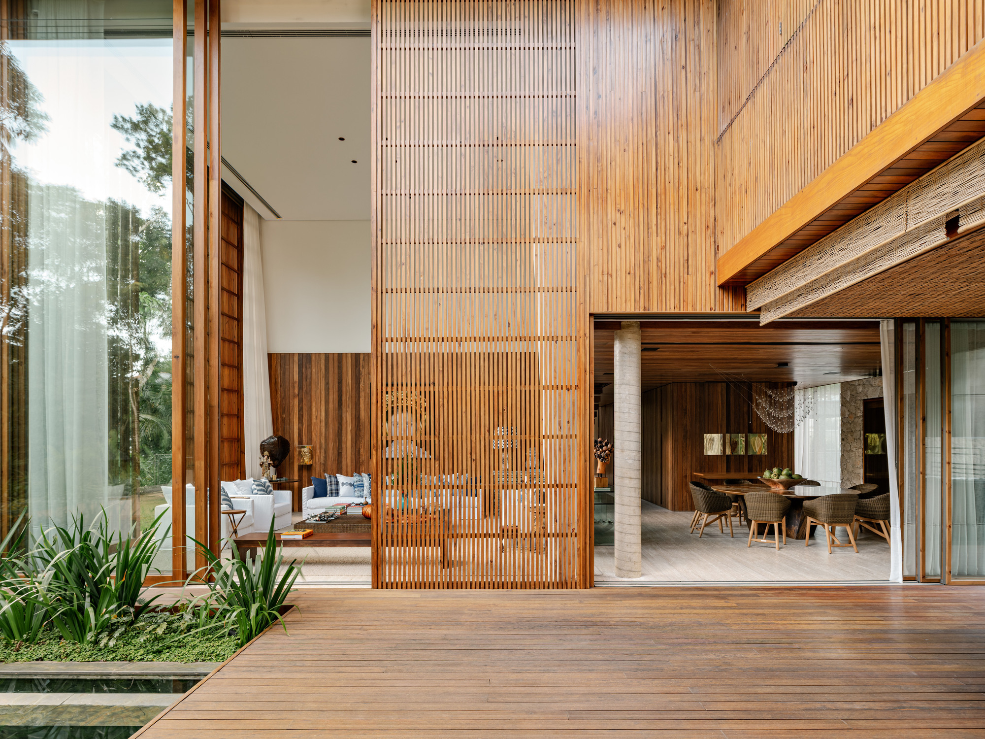 Courtyard view showing layered timber screens and decking connecting interior living spaces