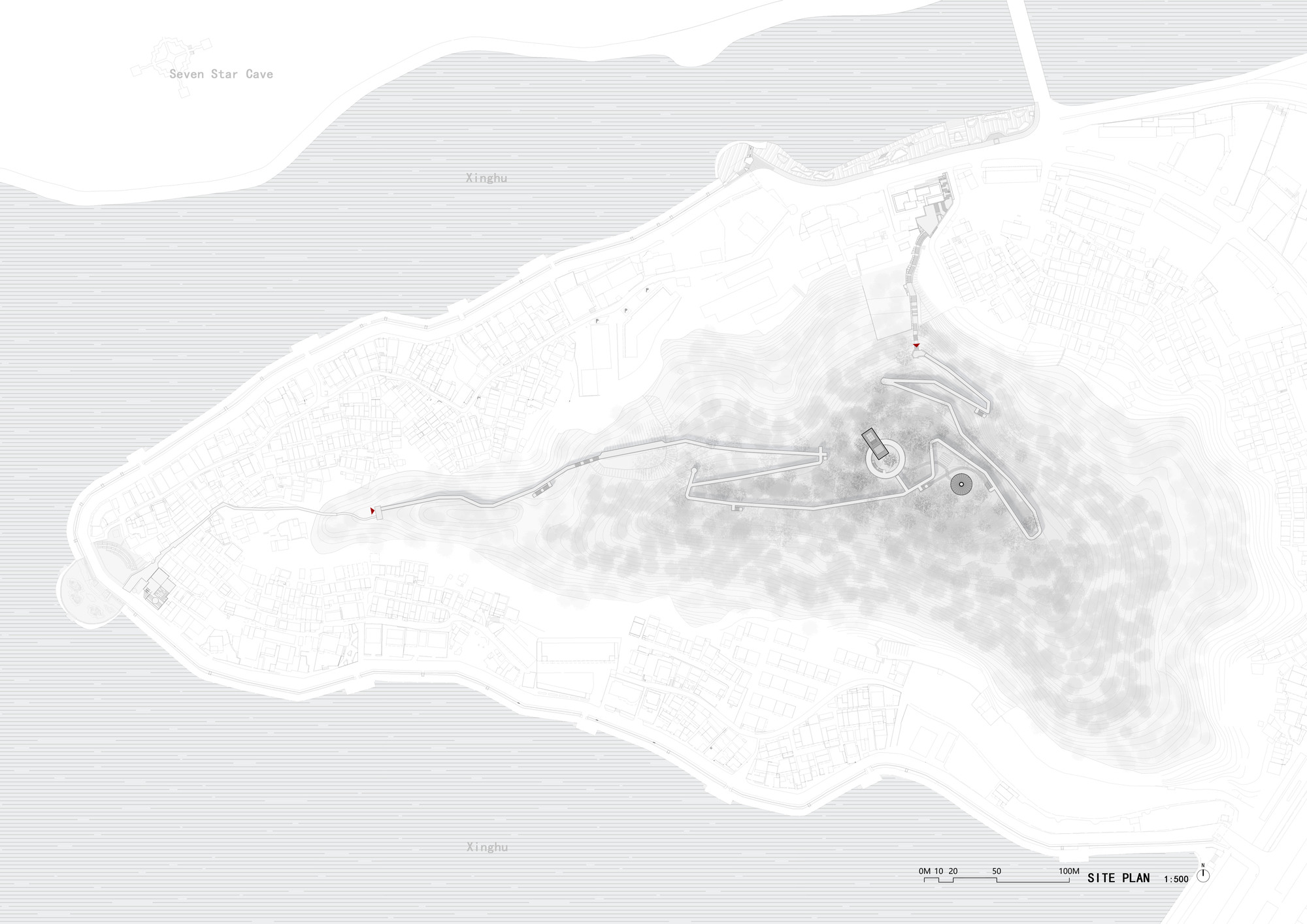Site plan drawing showing the building footprint along a curved waterfront with topographic contours and pathways