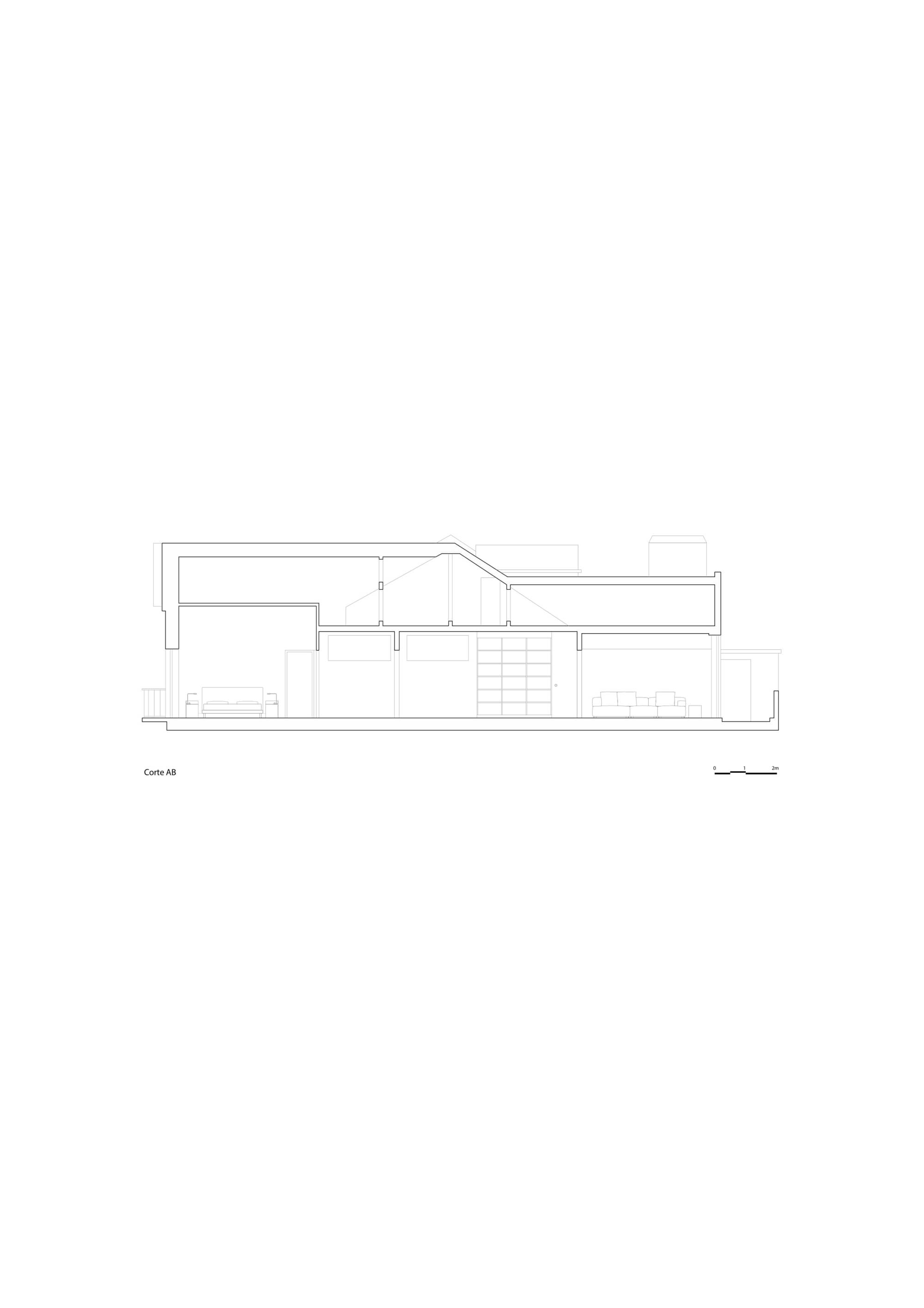 Section drawing cutting through the pitched roof and open interior, with furniture outlines and a shelving wall in the middle