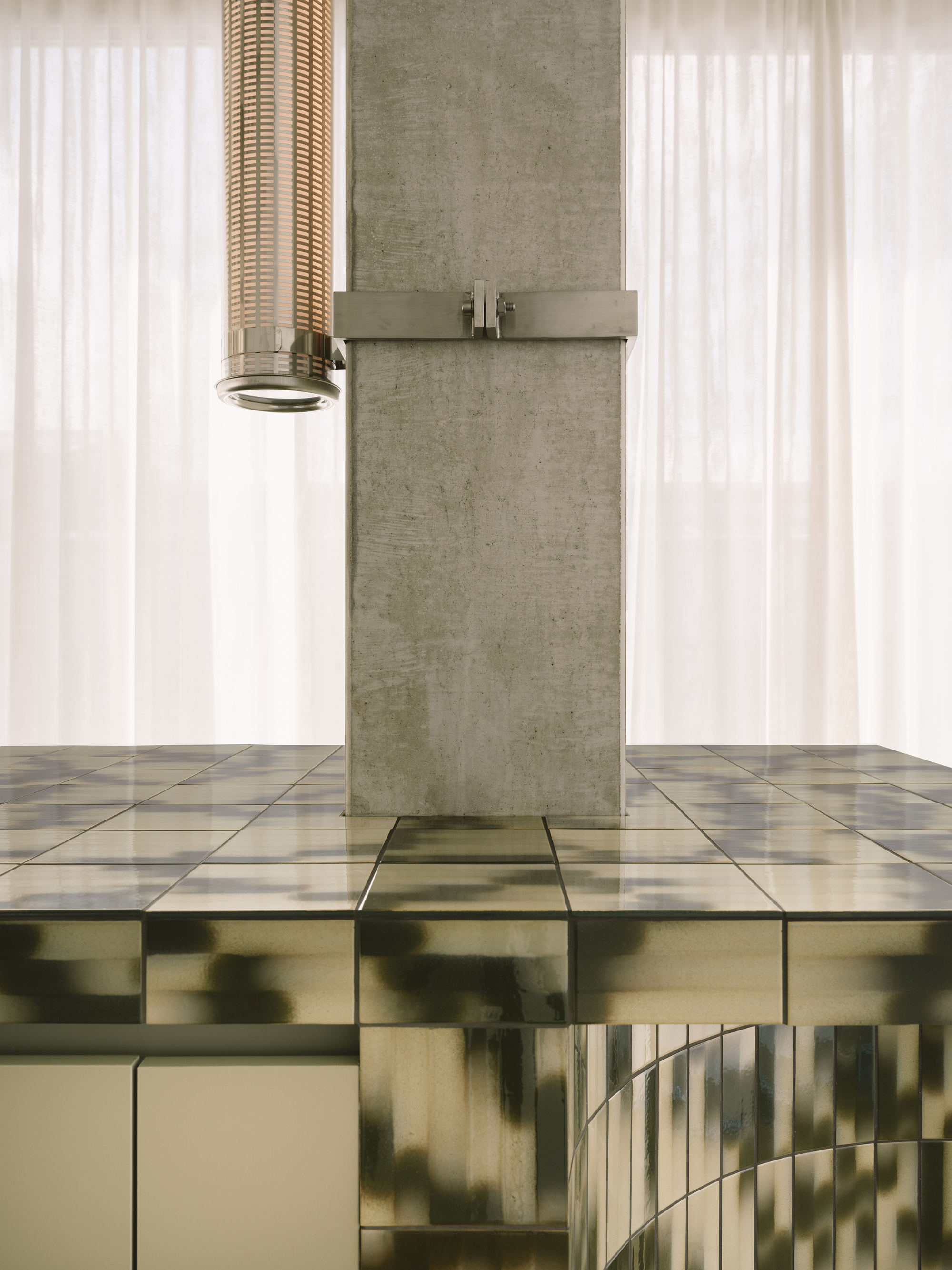 Concrete column with metal bracket extending through a mirrored floor reflecting white curtains and pendant light