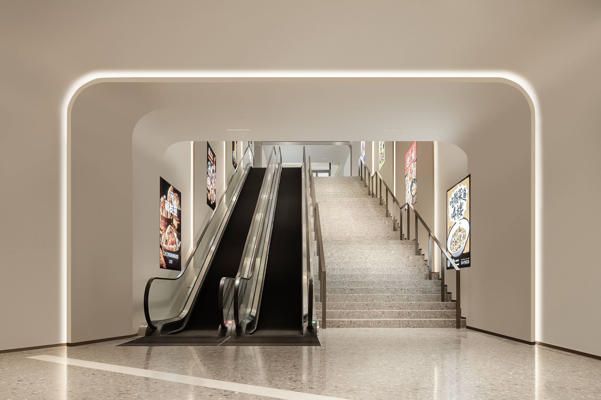 Rounded portal framing escalators and stairs with backlit edges and advertising screens on walls