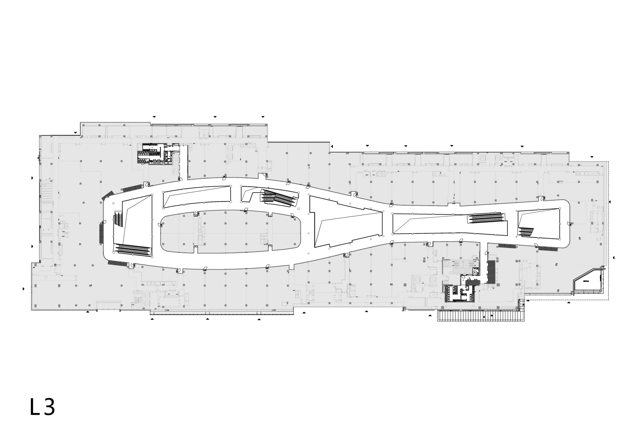 Floor plan drawing showing an elongated curvilinear volume with service cores and structural grid
