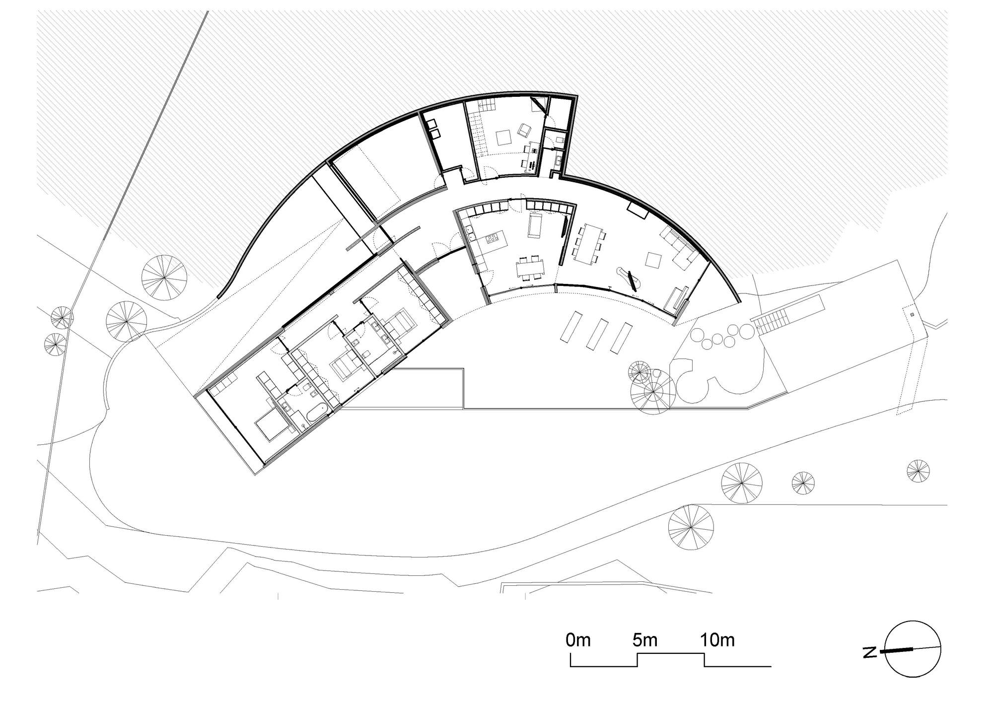 Floor plan drawing of a curved, boomerang-shaped house showing living areas, bedrooms, terrace, surrounding trees and a scale bar with north arrow
