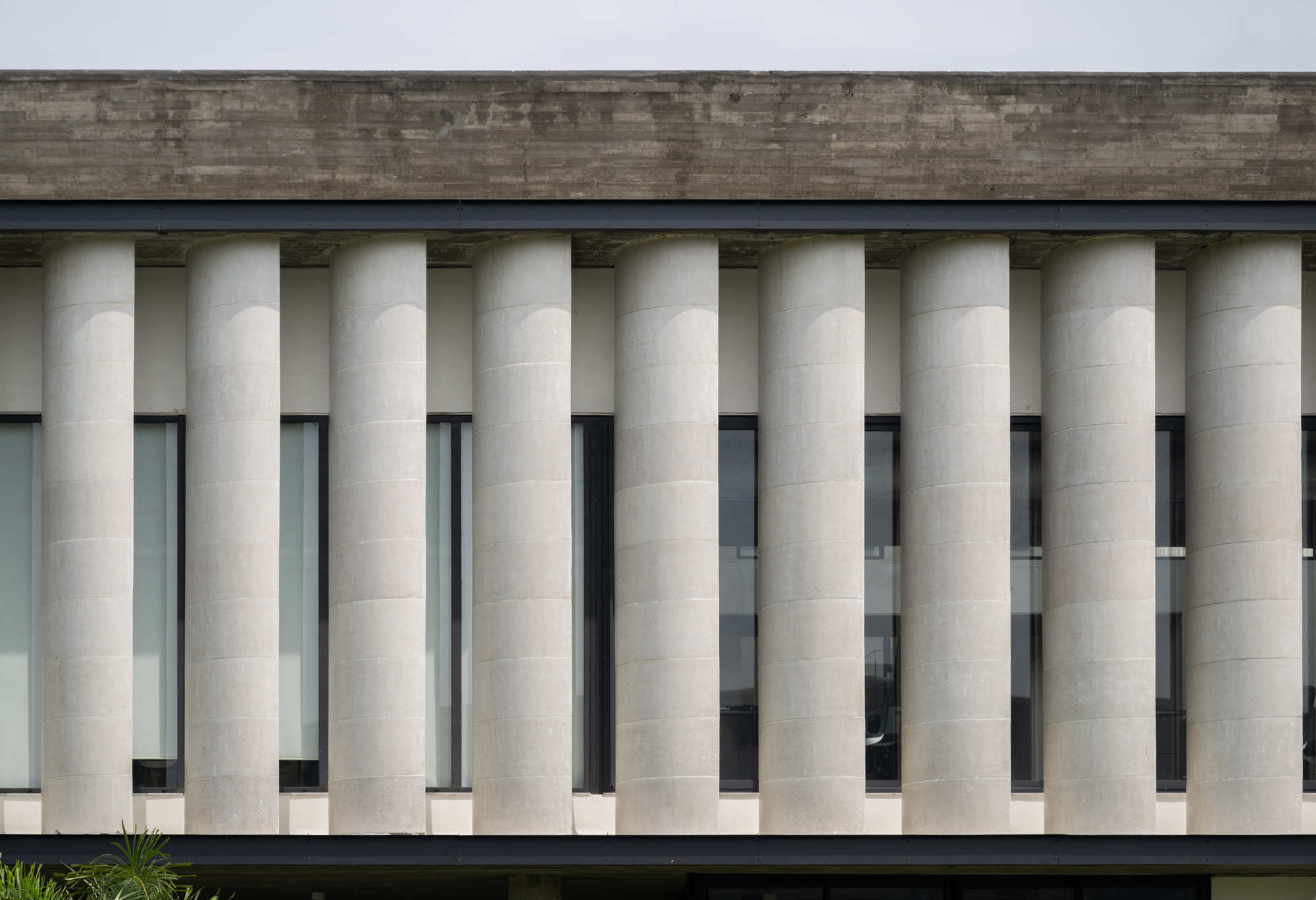Close-up of vertical fins with narrow glazed slots between the precast concrete elements