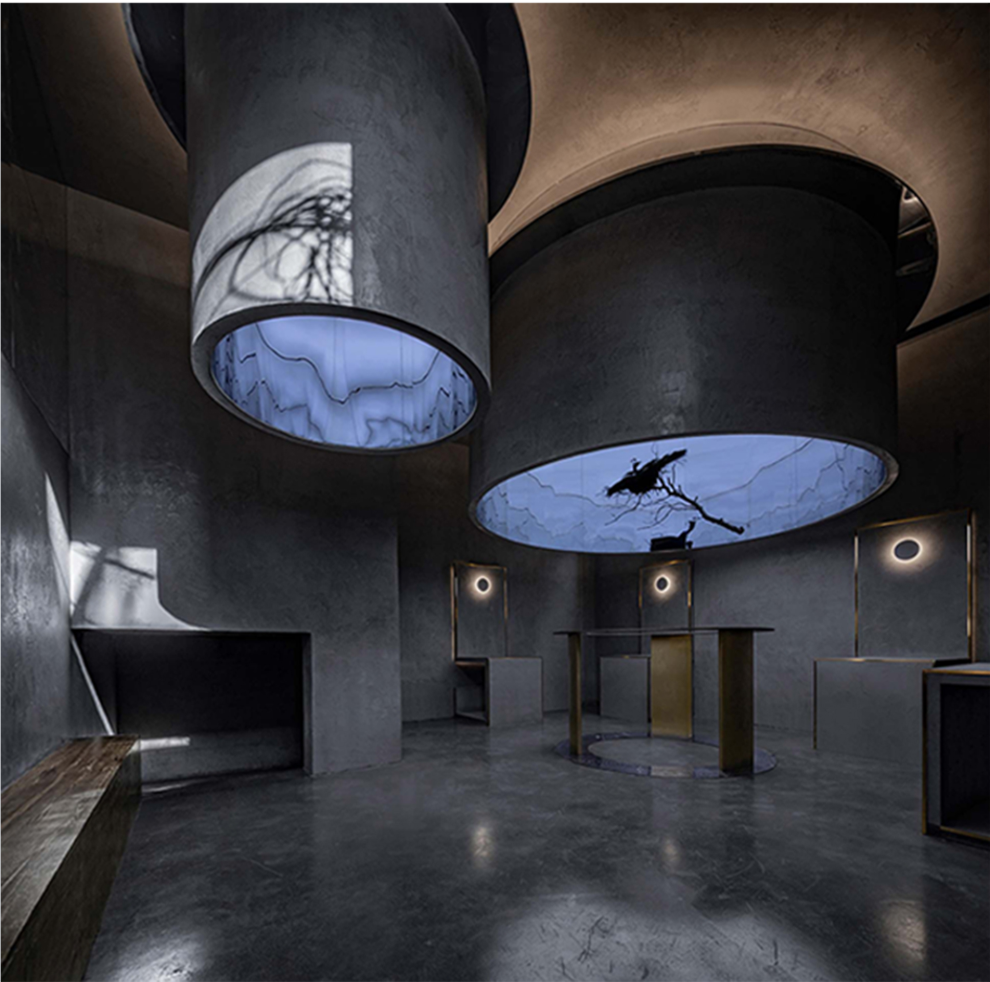 Dark art space with cylindrical gallery volumes and atmospheric lighting.