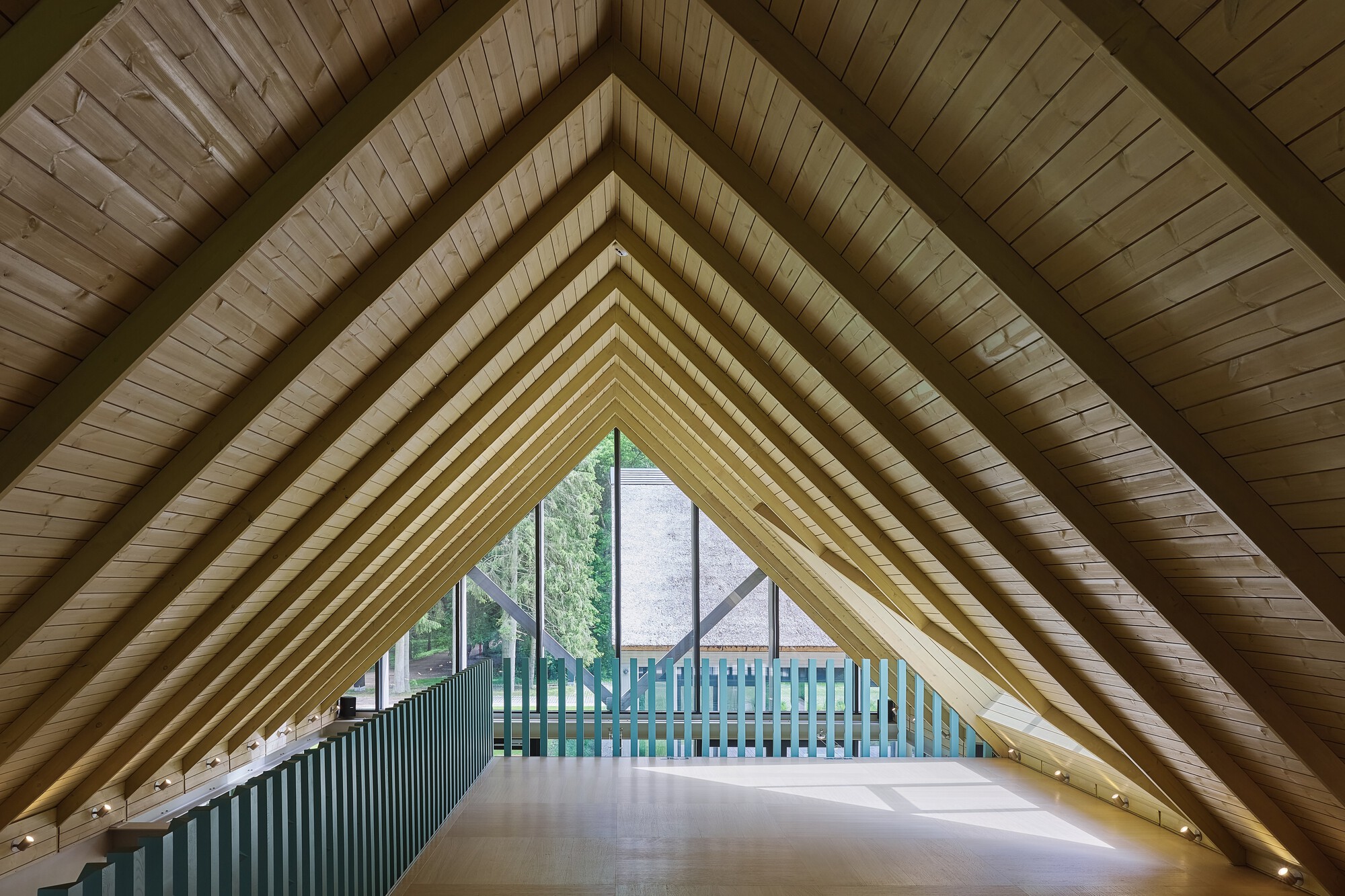 Interior view of exposed timber rafter ceiling forming a symmetrical triangular vault