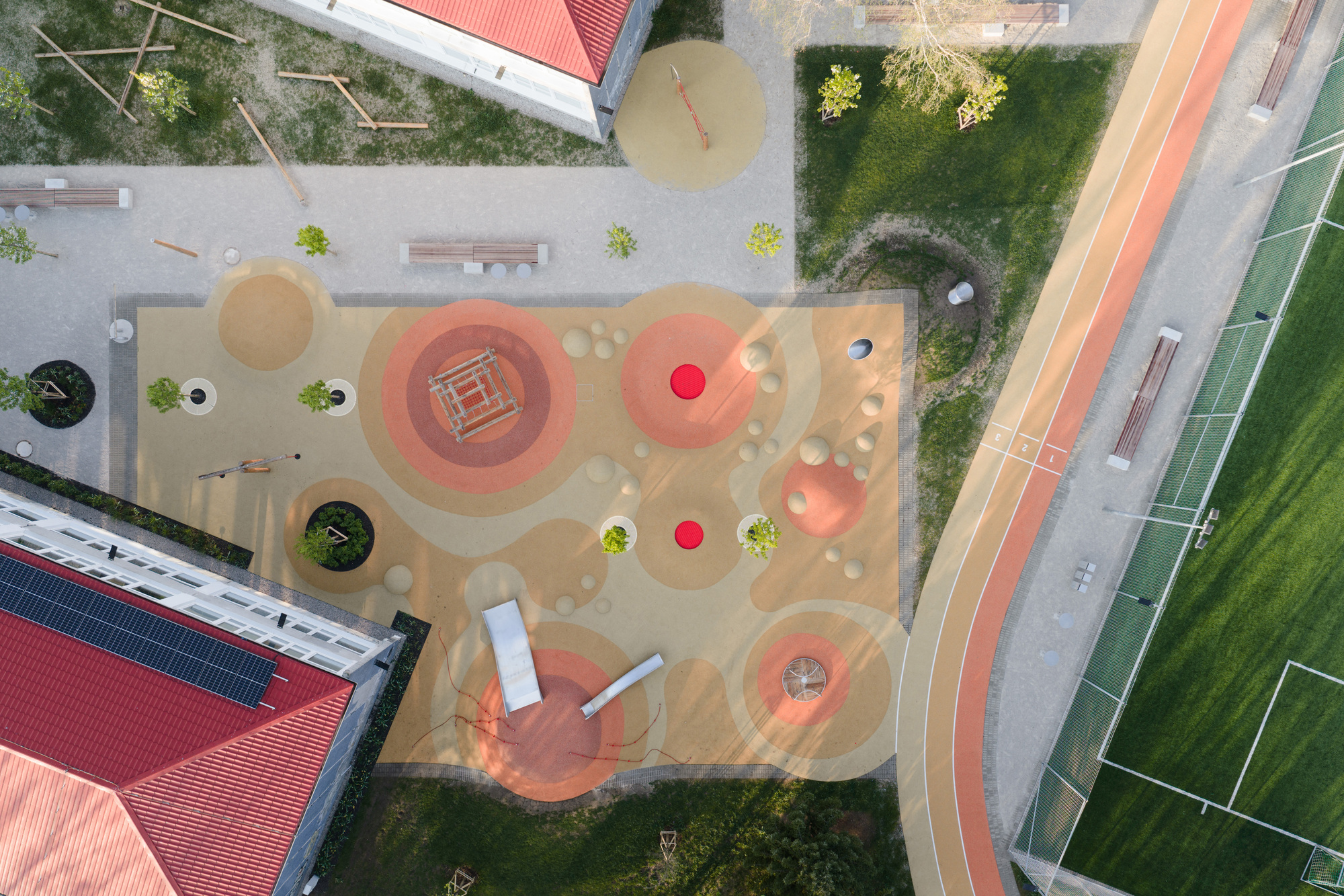 Overhead view of the play yard showing concentric circles and colored climbing mounds
