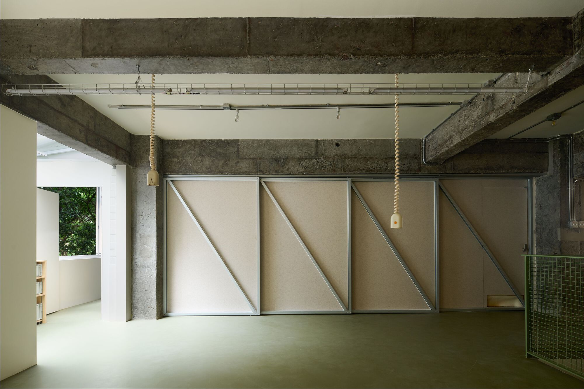 Three sliding panels with triangular bracing fully extended across the concrete frame space