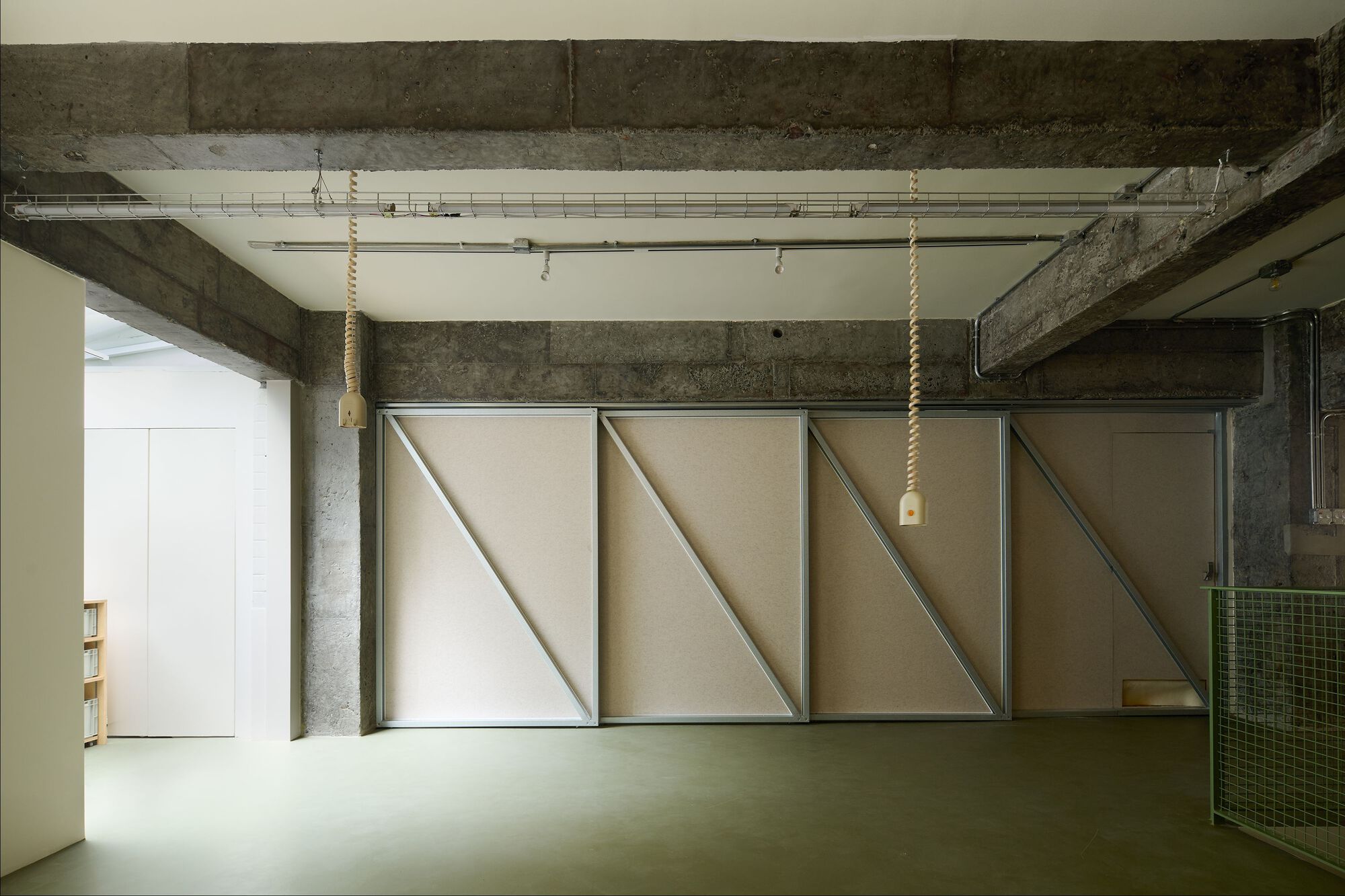 Interior with concrete columns and sliding panels closing off the rear study area