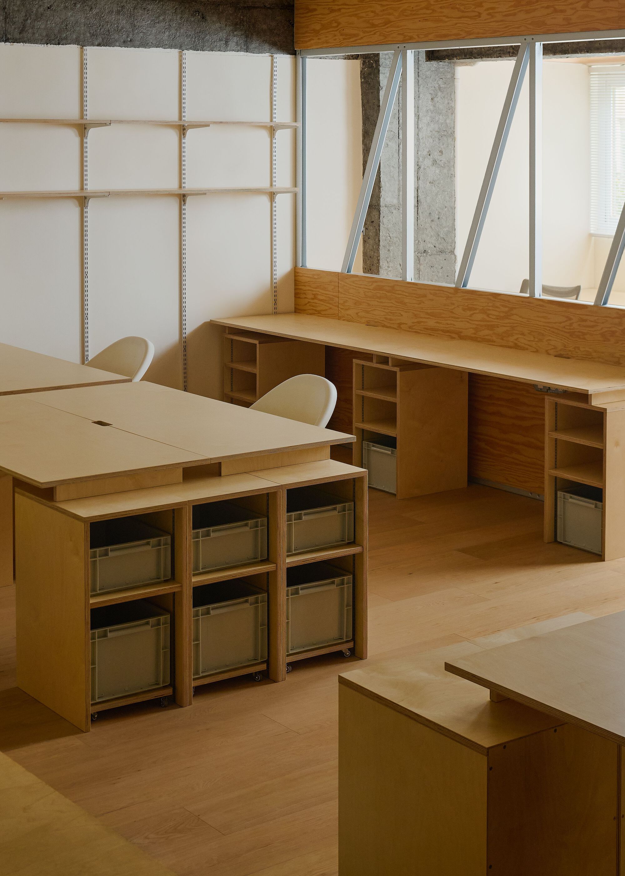 Timber desks with modular storage bins below adjustable panel wall and diagonal-braced glazed partition