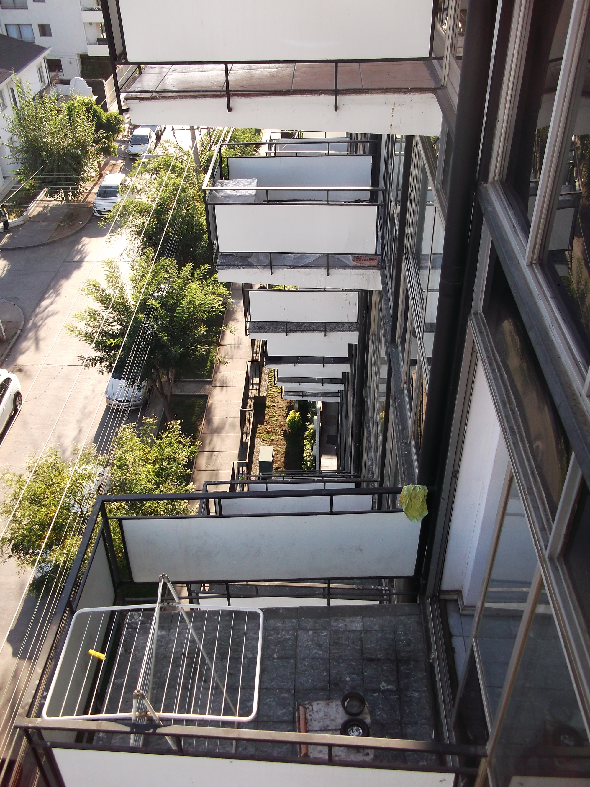 View down into the courtyard showing offset balconies and planted terraces between the tower wings