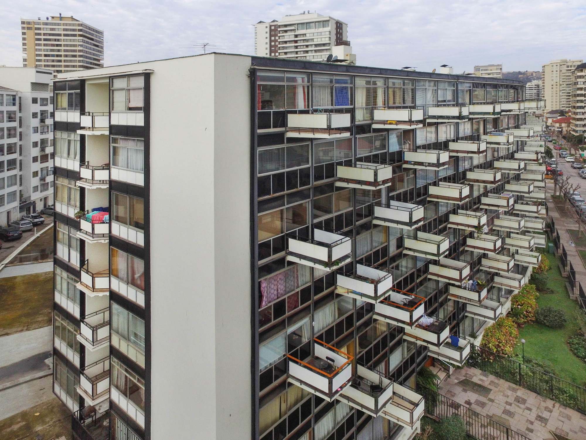 Residential facade with staggered balconies and glazed units set within a steel and concrete frame