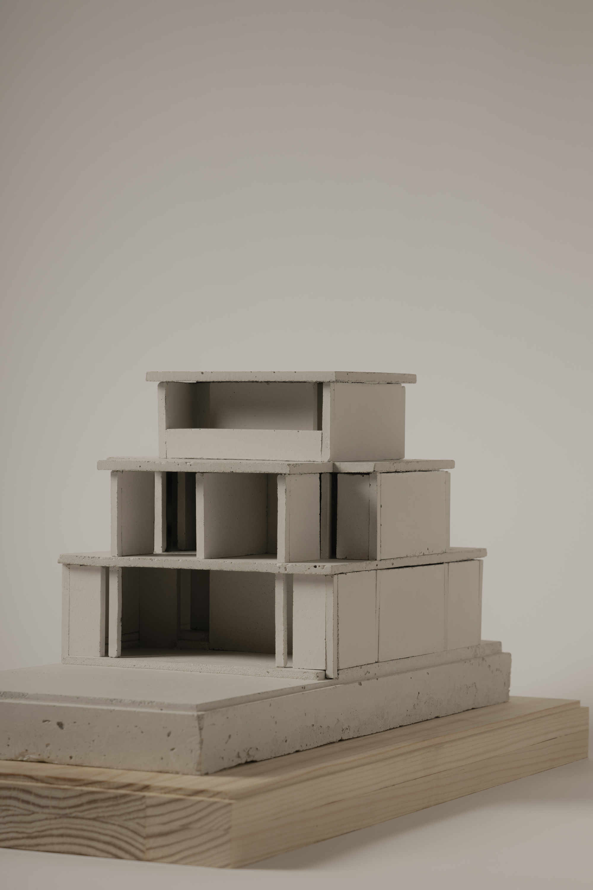 Sectional view of a concrete massing model revealing internal columns and terraced levels