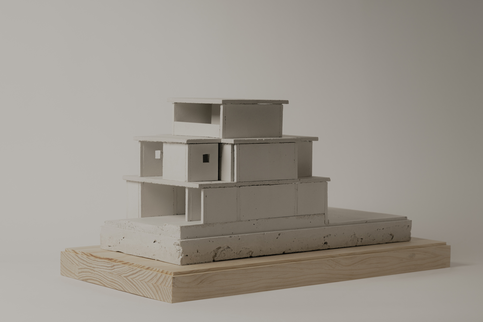 Front elevation of the model revealing stacked volumes with cantilevered slabs and recessed openings