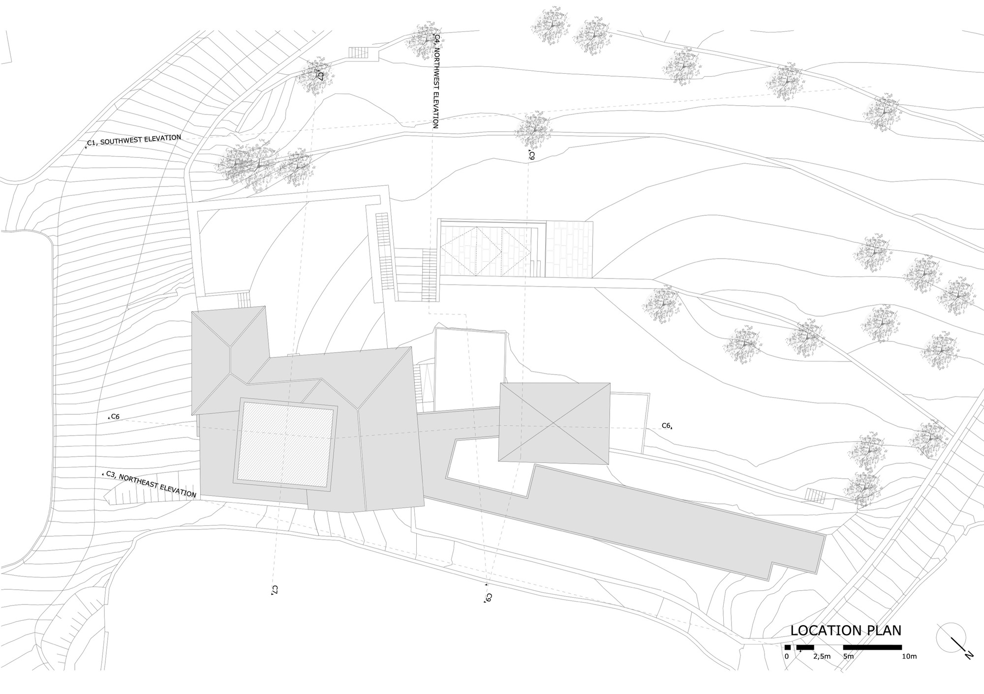 Location plan drawing showing building footprints on sloped site with contour lines and tree symbols