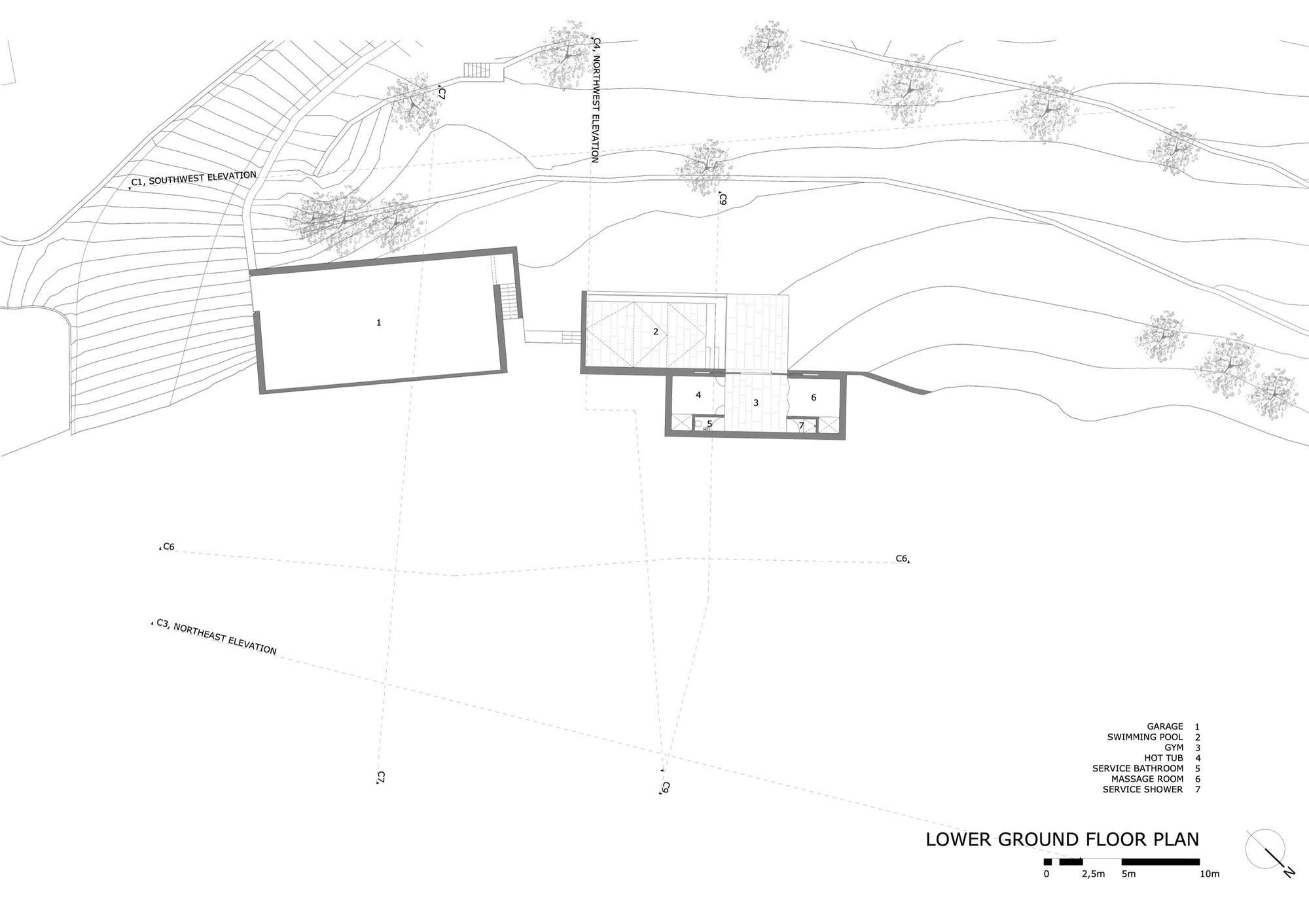 Lower ground floor plan showing scattered volumes on a sloping terrain with contour lines and trees