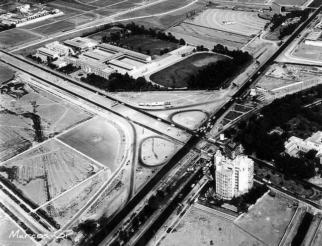 Aerial view of the tower beside highway interchanges and rectangular building complexes