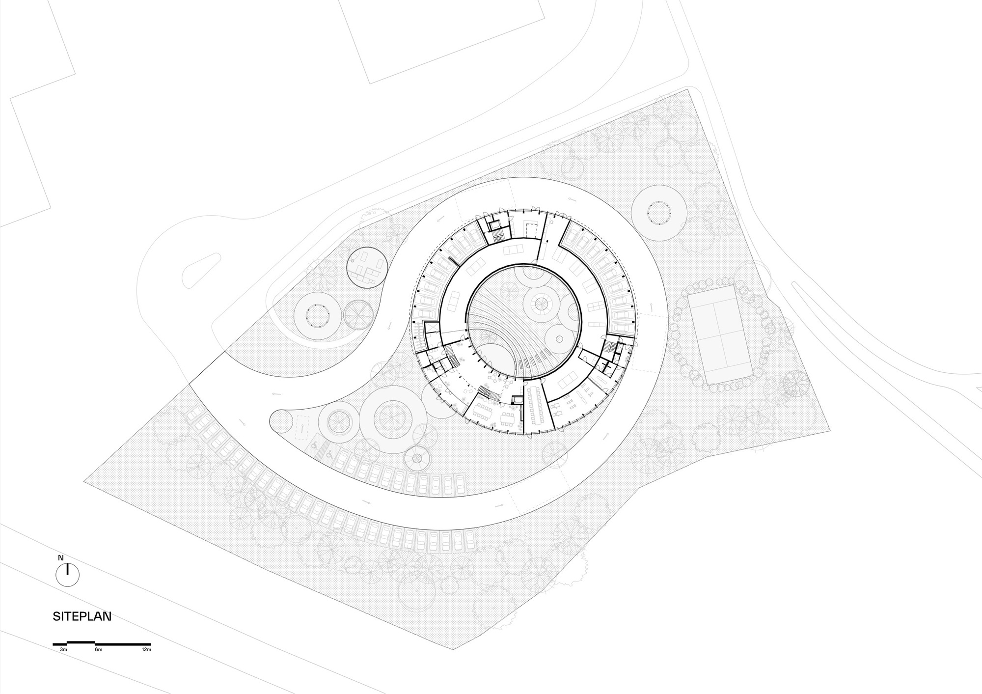 Site plan drawing showing a circular building surrounded by landscaping and adjacent structures
