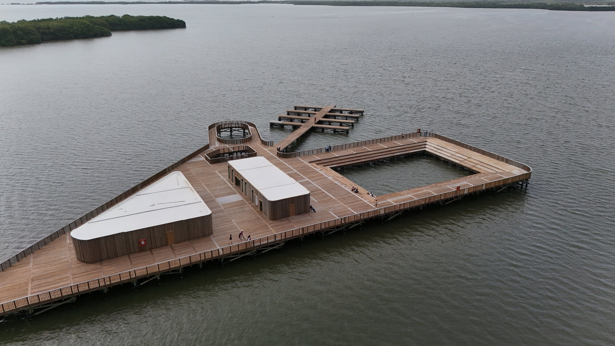 Aerial view of the timber boardwalk complex with pavilions and piers extending into the lake