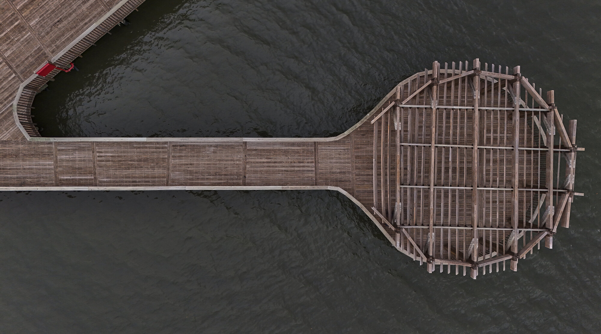 Overhead view of the circular timber platform with radial decking and structural framing exposed