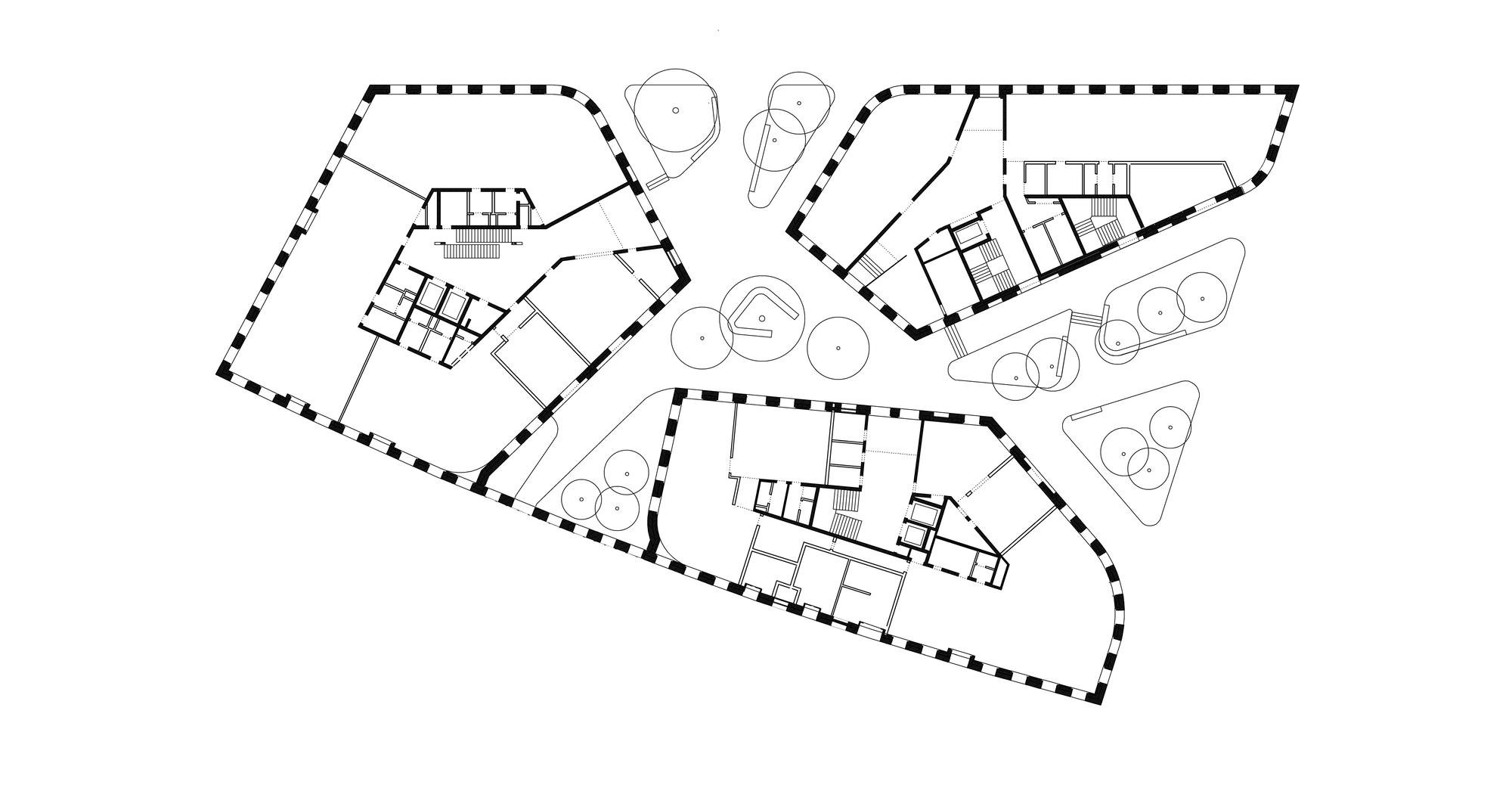 Floor plan drawing showing three irregularly shaped volumes connected around a central landscaped courtyard