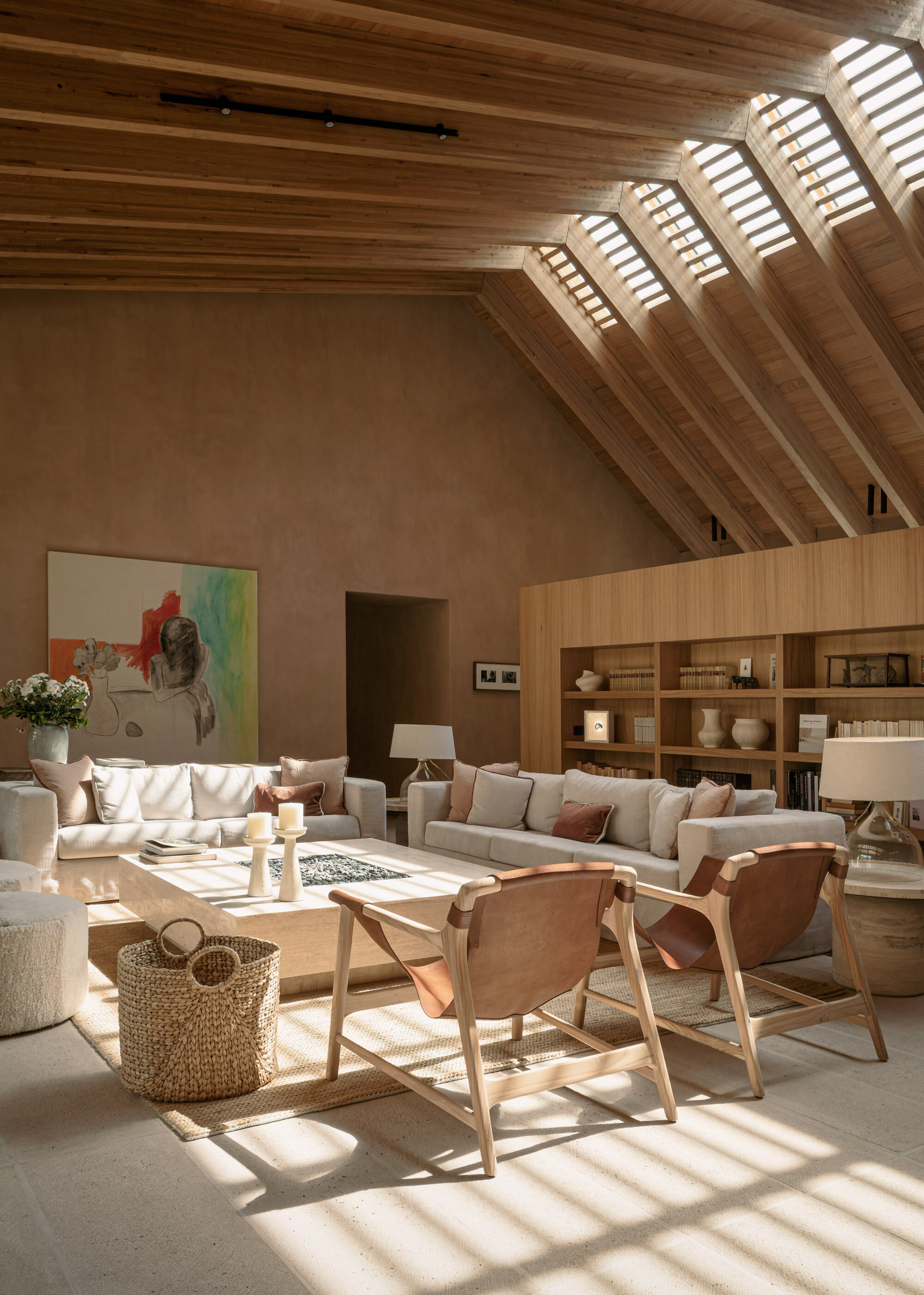 Pitched roof with slatted timber skylights creating bands of light across the floor below