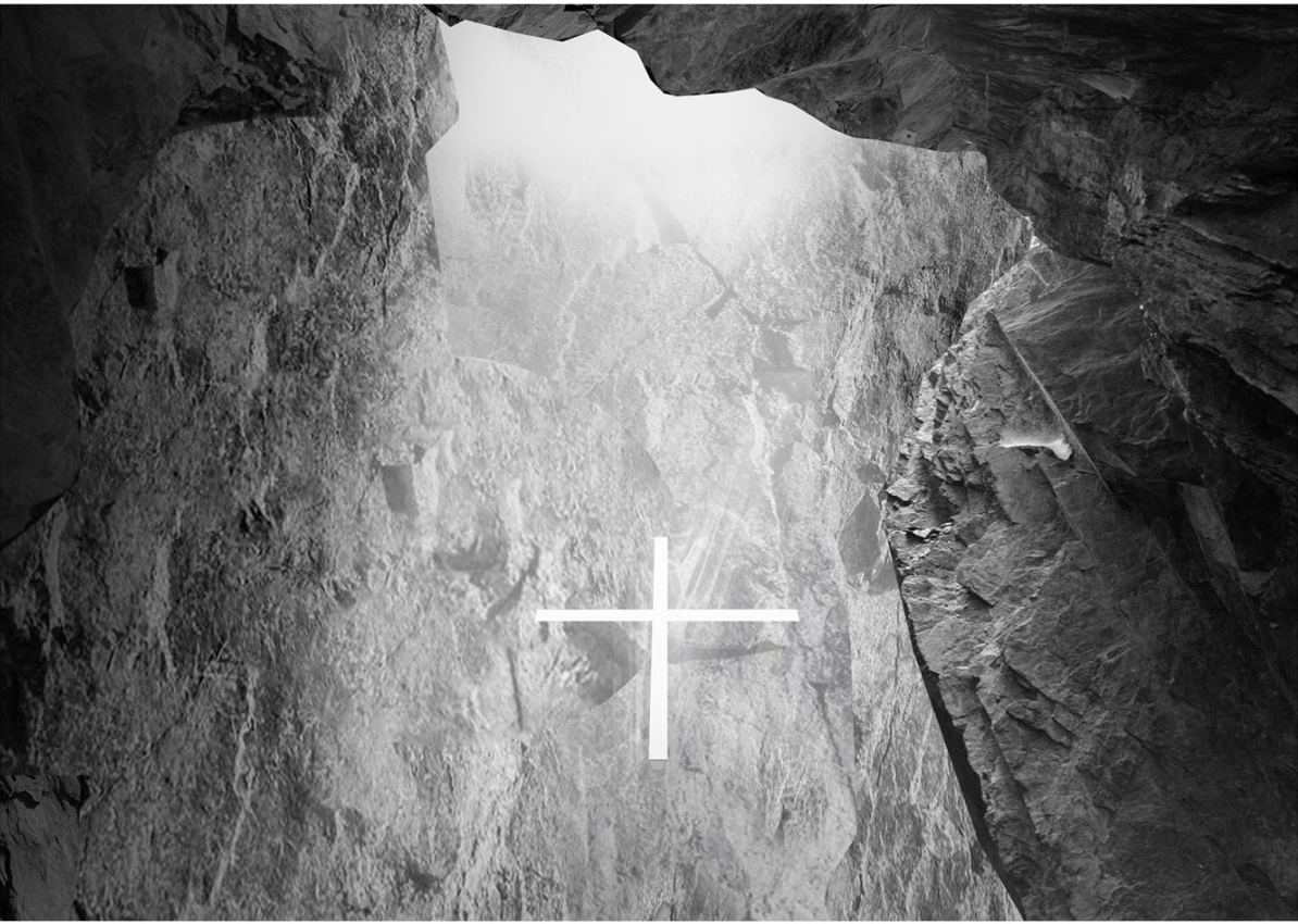A glowing glass cross illuminates the rock-hewn chapel interior.