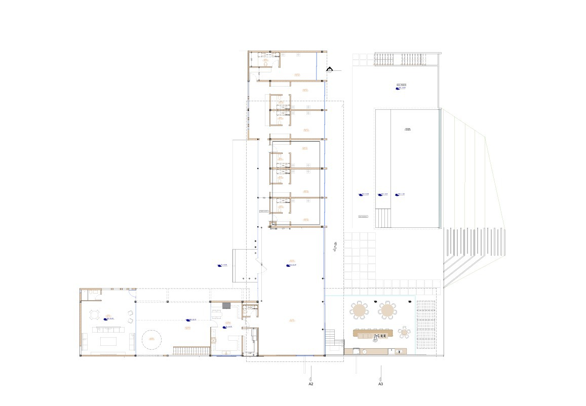 Floor plan drawing showing angled wings and terraced outdoor areas around a central courtyard