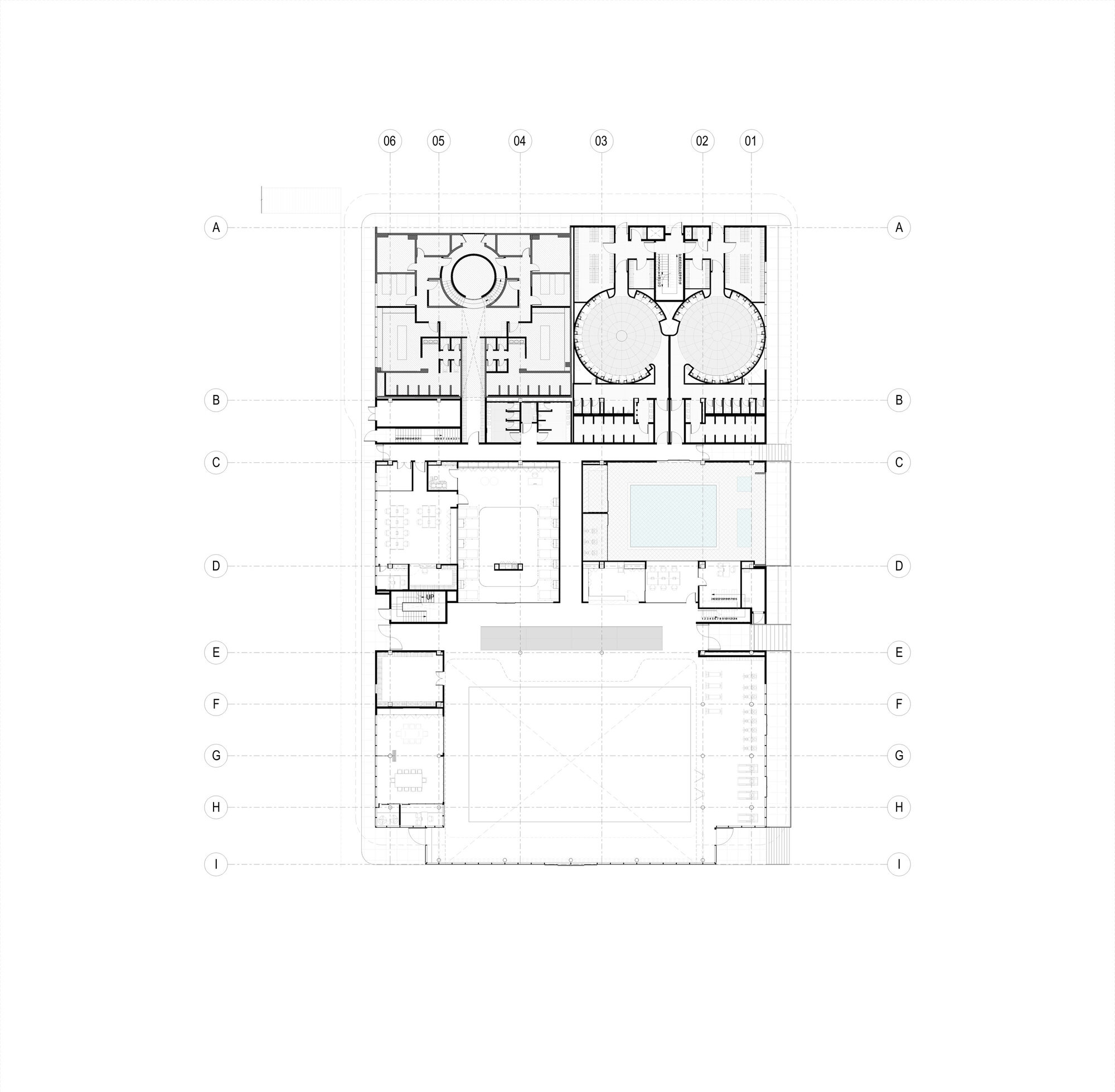 Floor plan showing two circular volumes on the upper portion and a large open field below