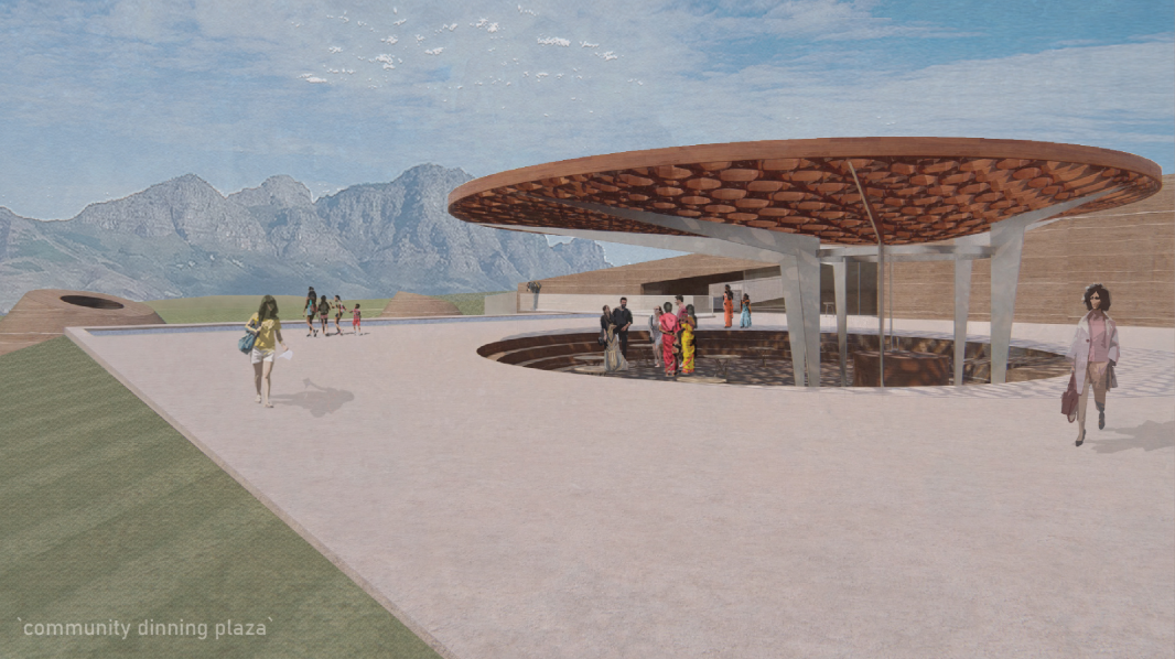Circular community dining plaza framed by vineyards and mountain views.
