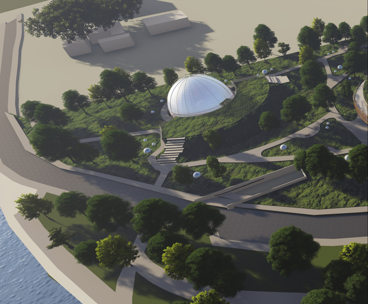 Aerial view showing the domed cinema embedded within a flowing landscape and pedestrian network.