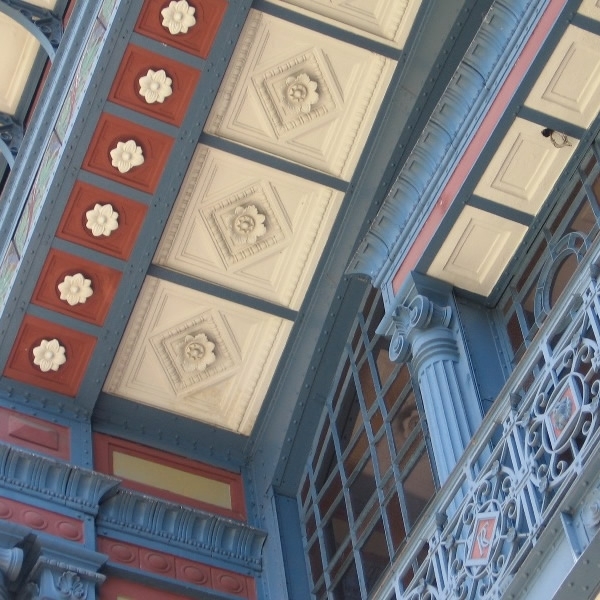 Upward view of the coffered ceiling with hexagonal panels and decorative rosettes framed by blue painted beams