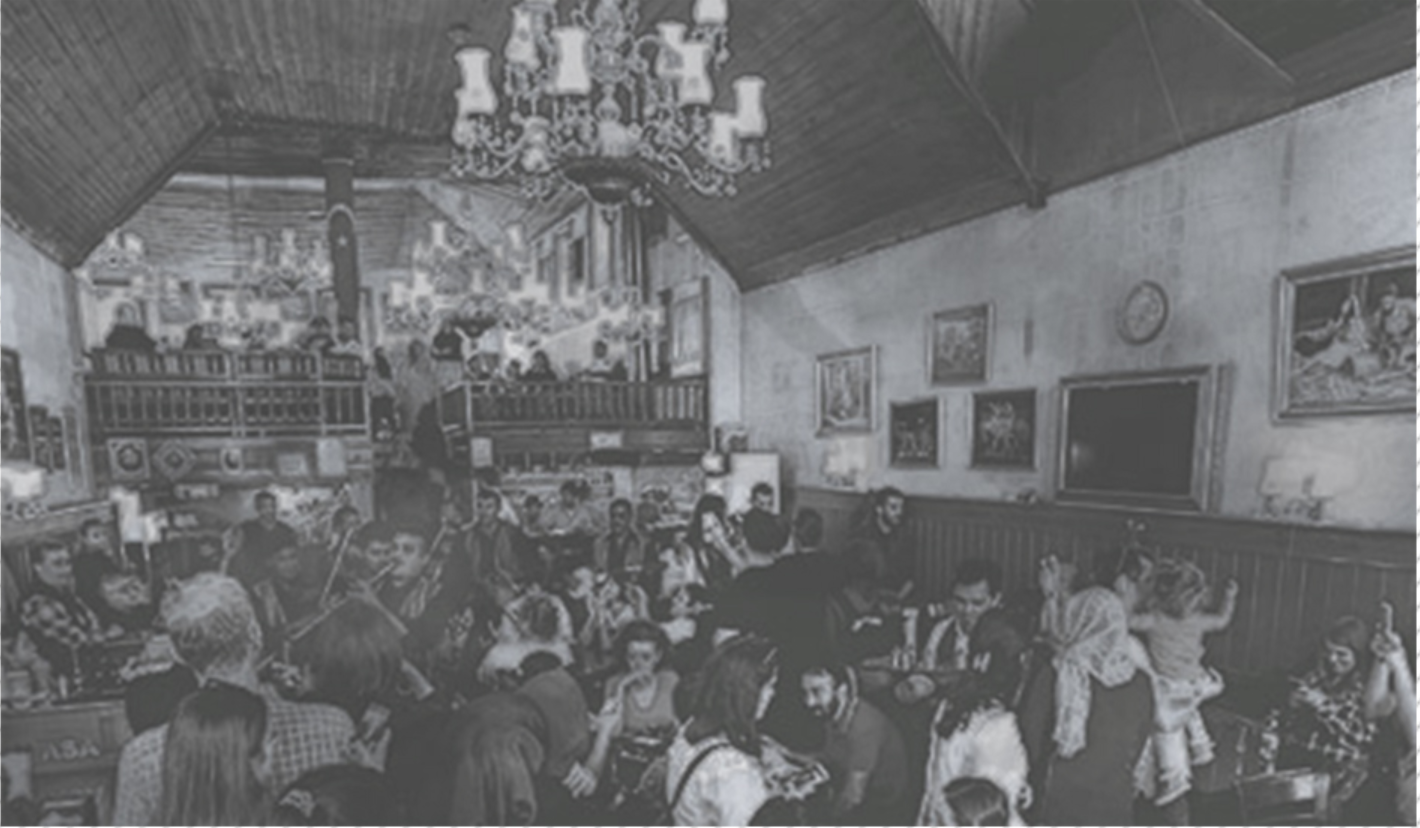 A vibrant heritage coffee house where communal gathering, ornament, and cultural exchange shape the interior atmosphere.
