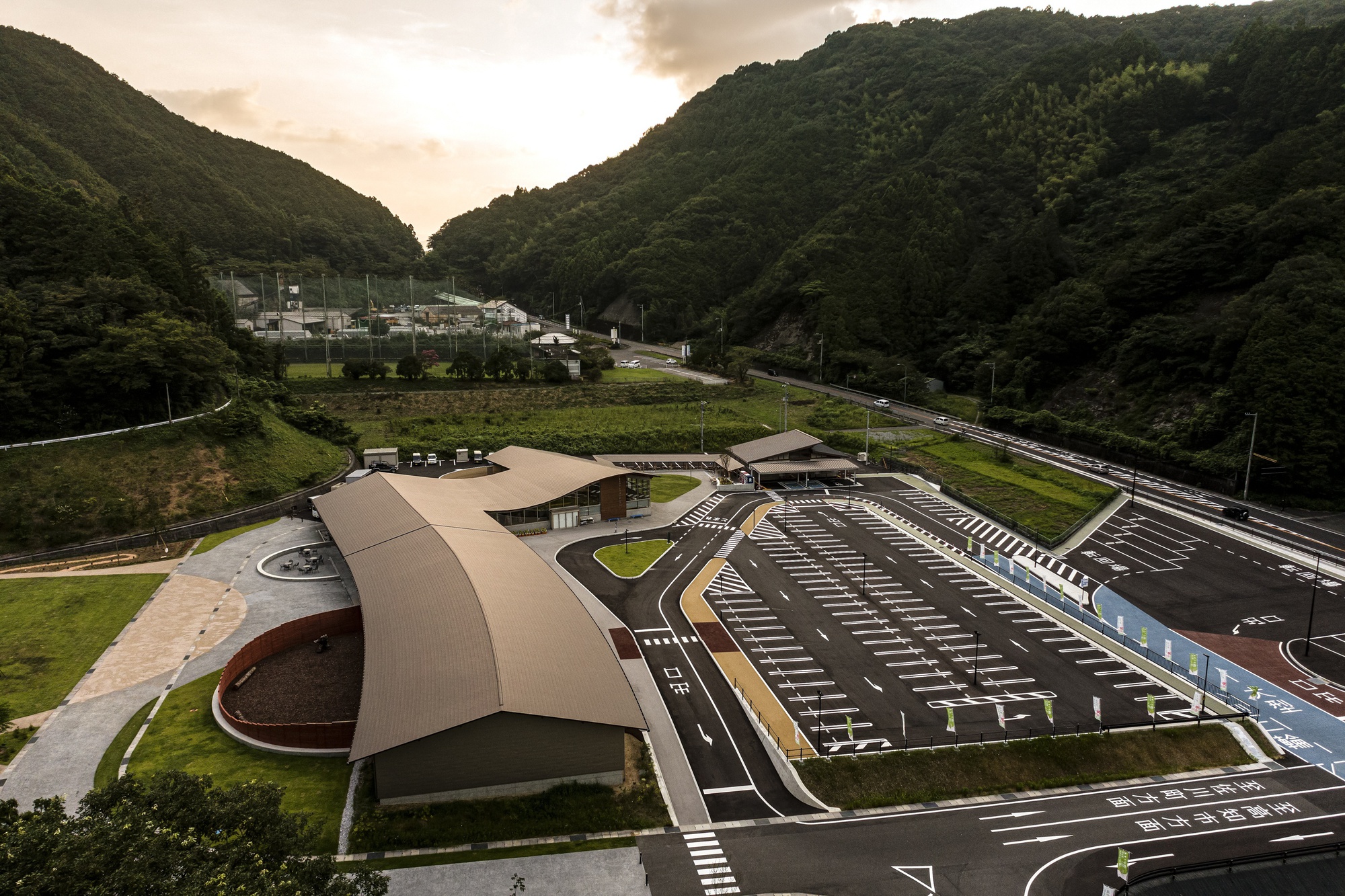 Elevated view of the arcing roof canopy over the parking lot at dusk