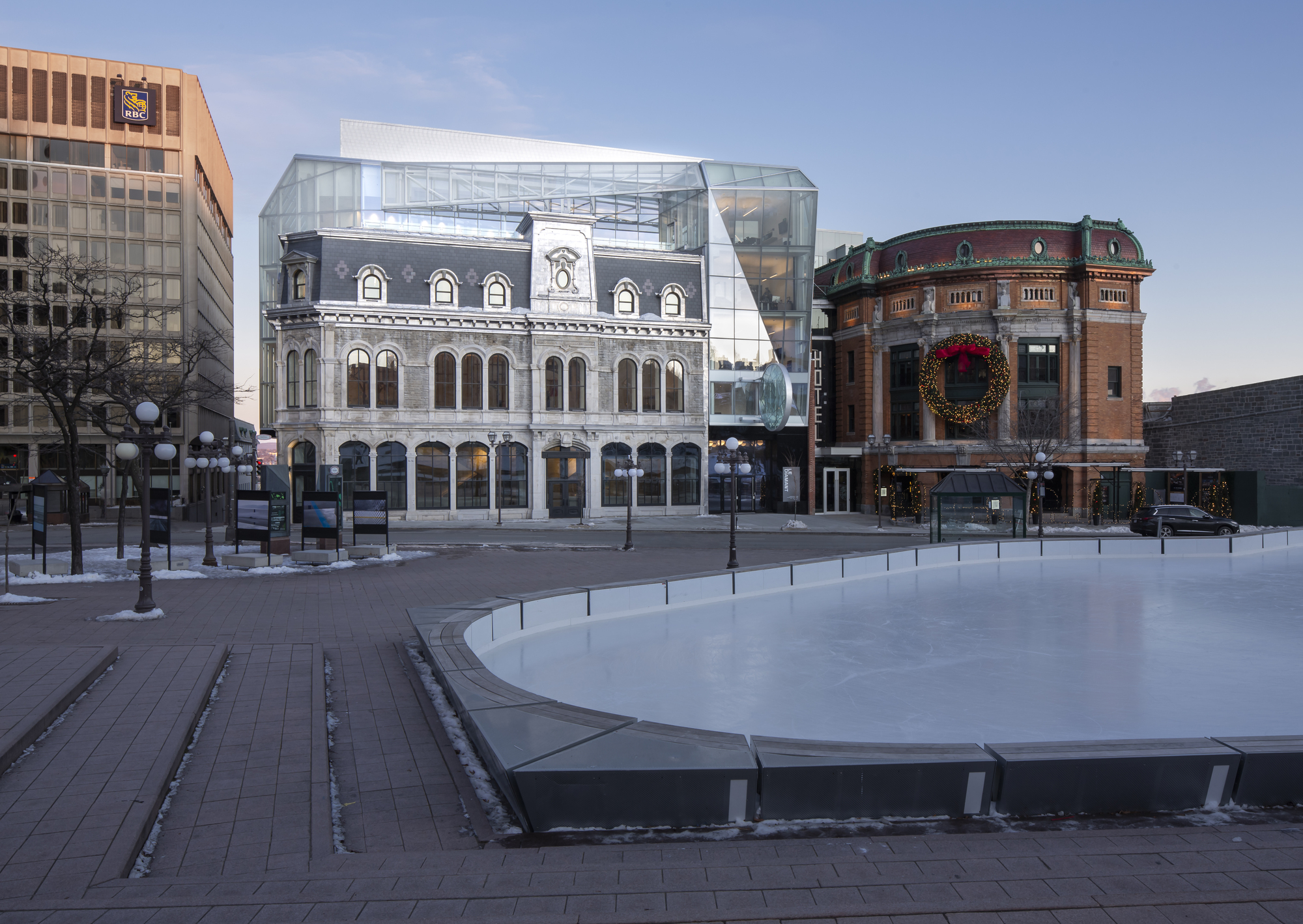 Plaza view showing the restored stone facade and glass addition with ice rink in the foreground