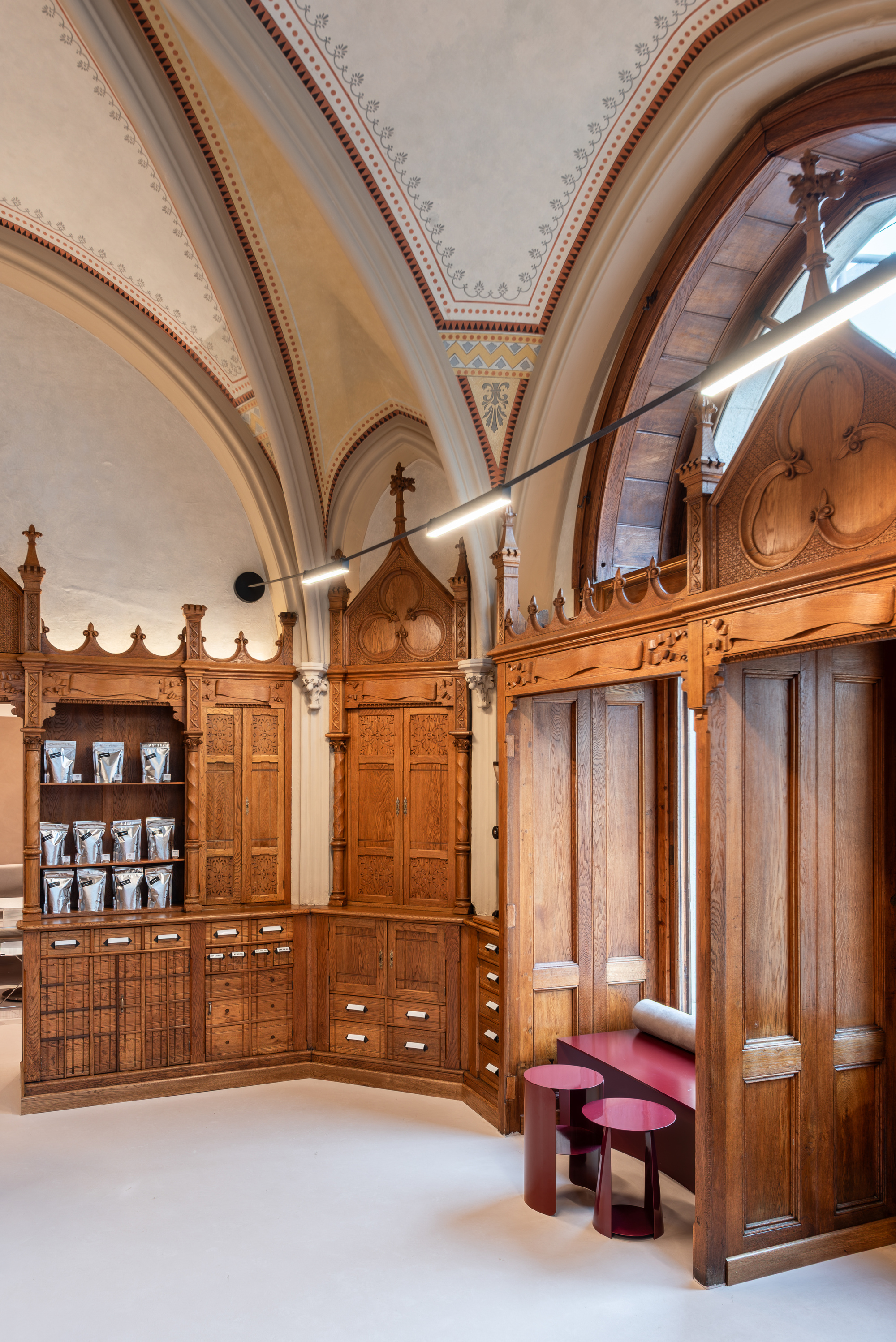 Interior with carved timber cabinetry and vaulted ceiling with decorative painted ribs