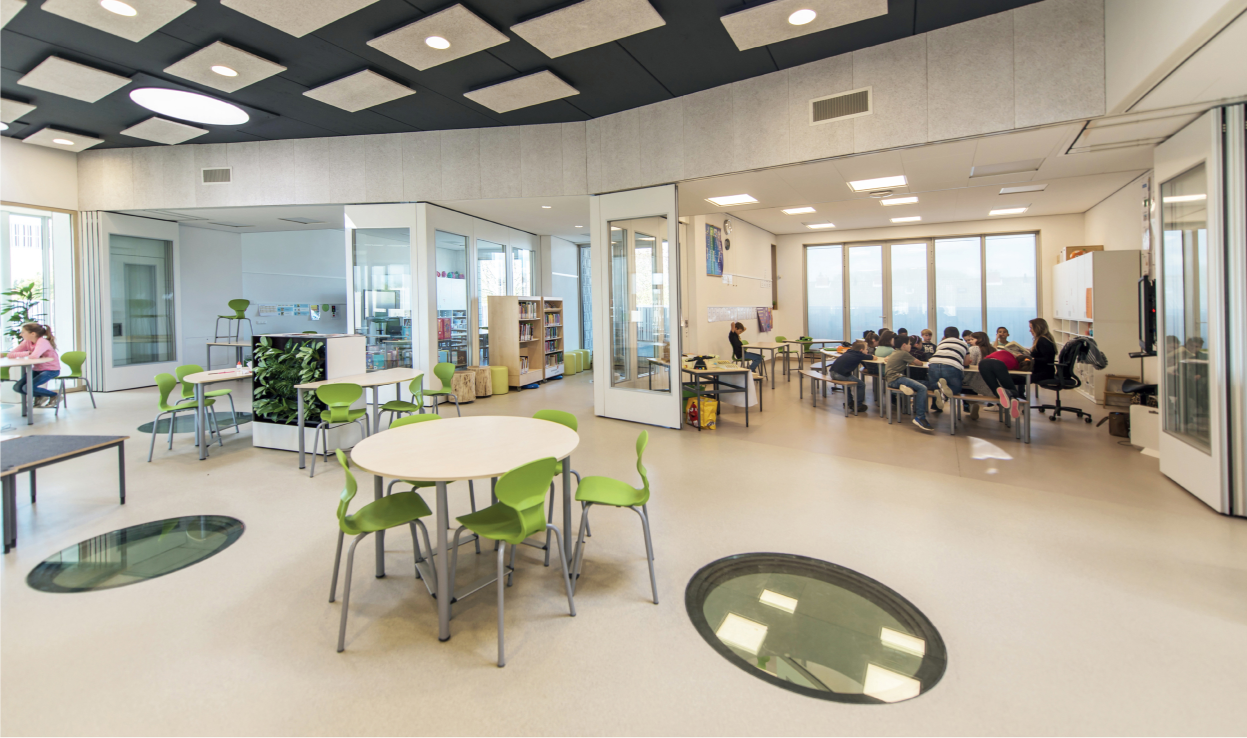 Flexible classrooms open into shared learning zones for collaborative education.