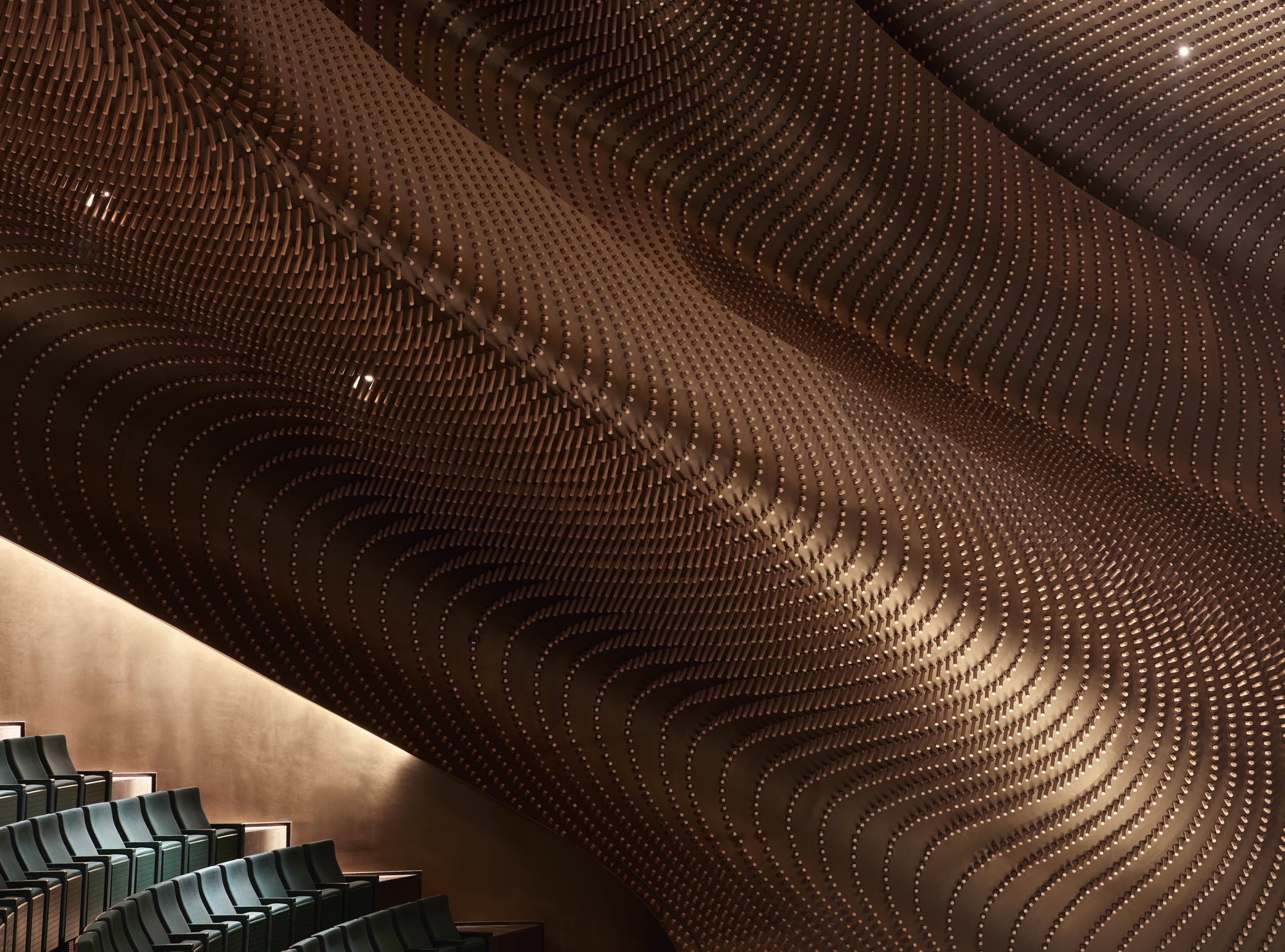 Detail of the contoured timber ceiling panels with concentric ridges and integrated light fixtures