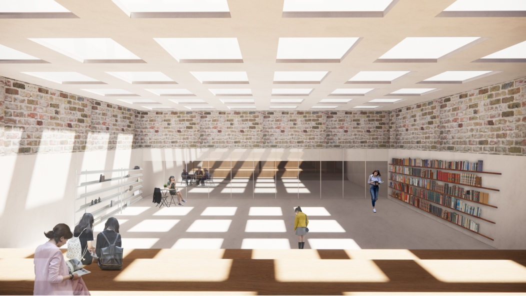 Daylit library interior where historic brickwork meets an open, flexible learning environment.