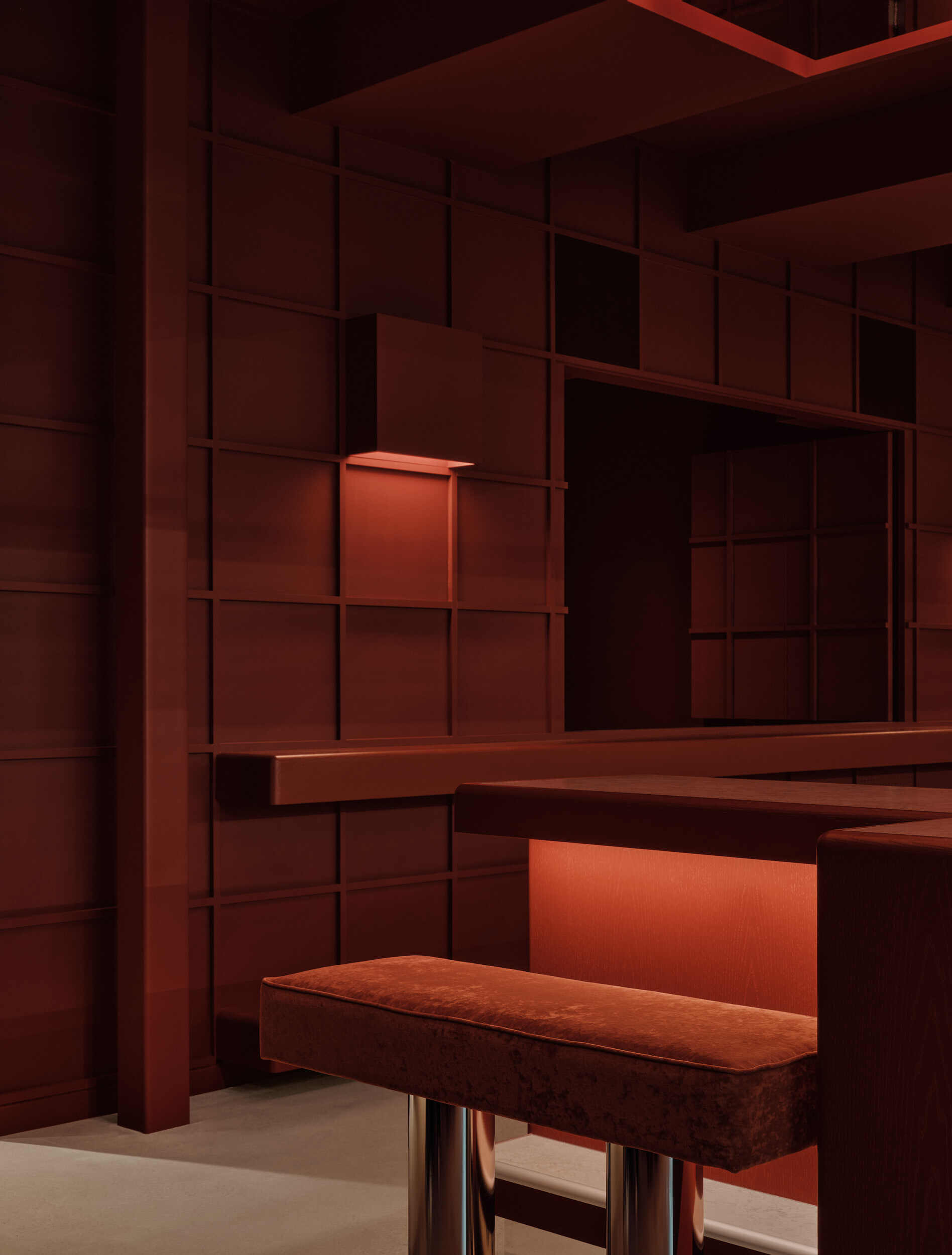 Corner detail of gridded terracotta shelving system with integrated bench and warm accent lighting