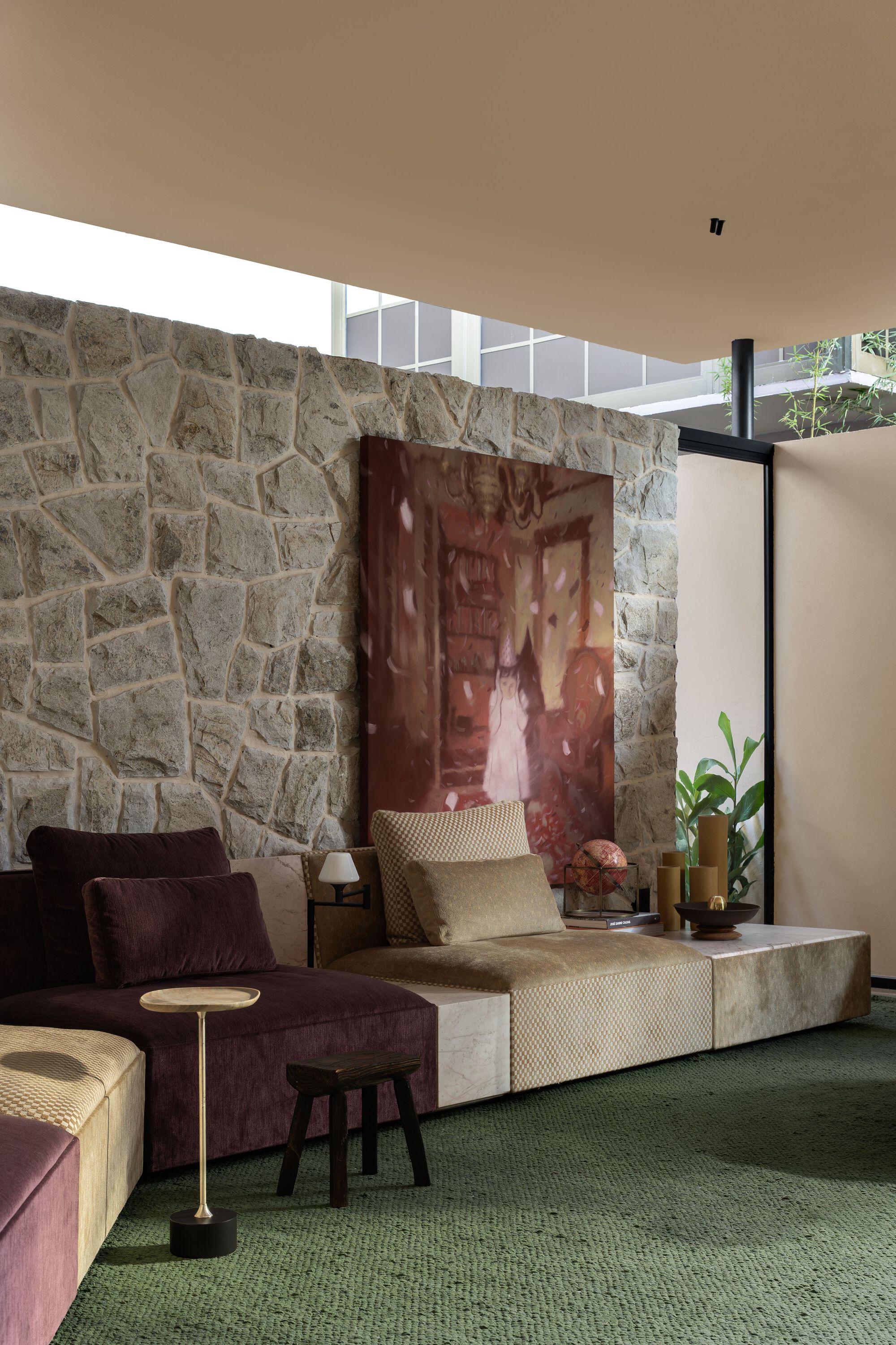 Clerestory window band illuminating the stone wall and artwork in the seating area below