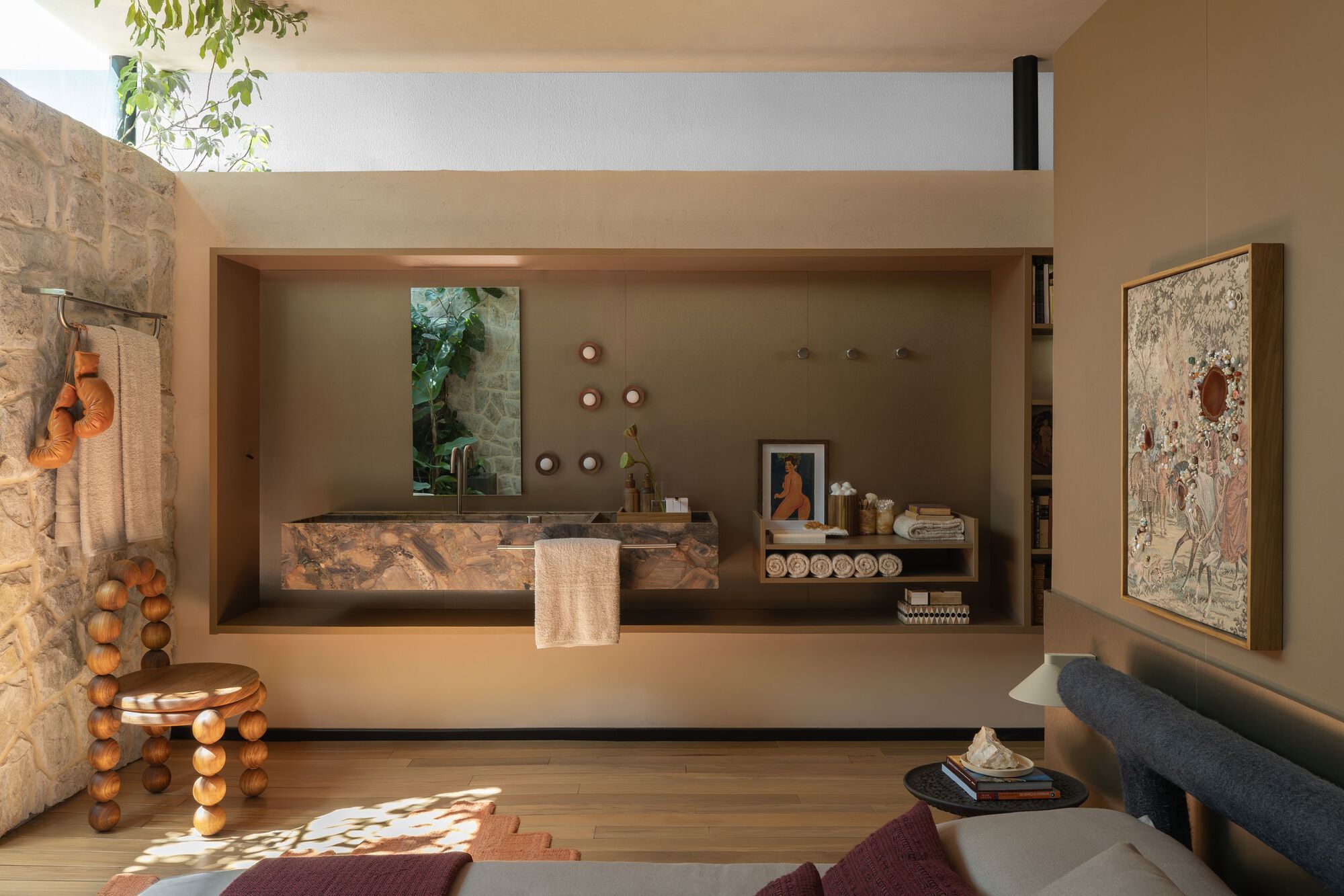 Bedroom suite with recessed marble vanity alcove and integrated open shelving at mezzanine level