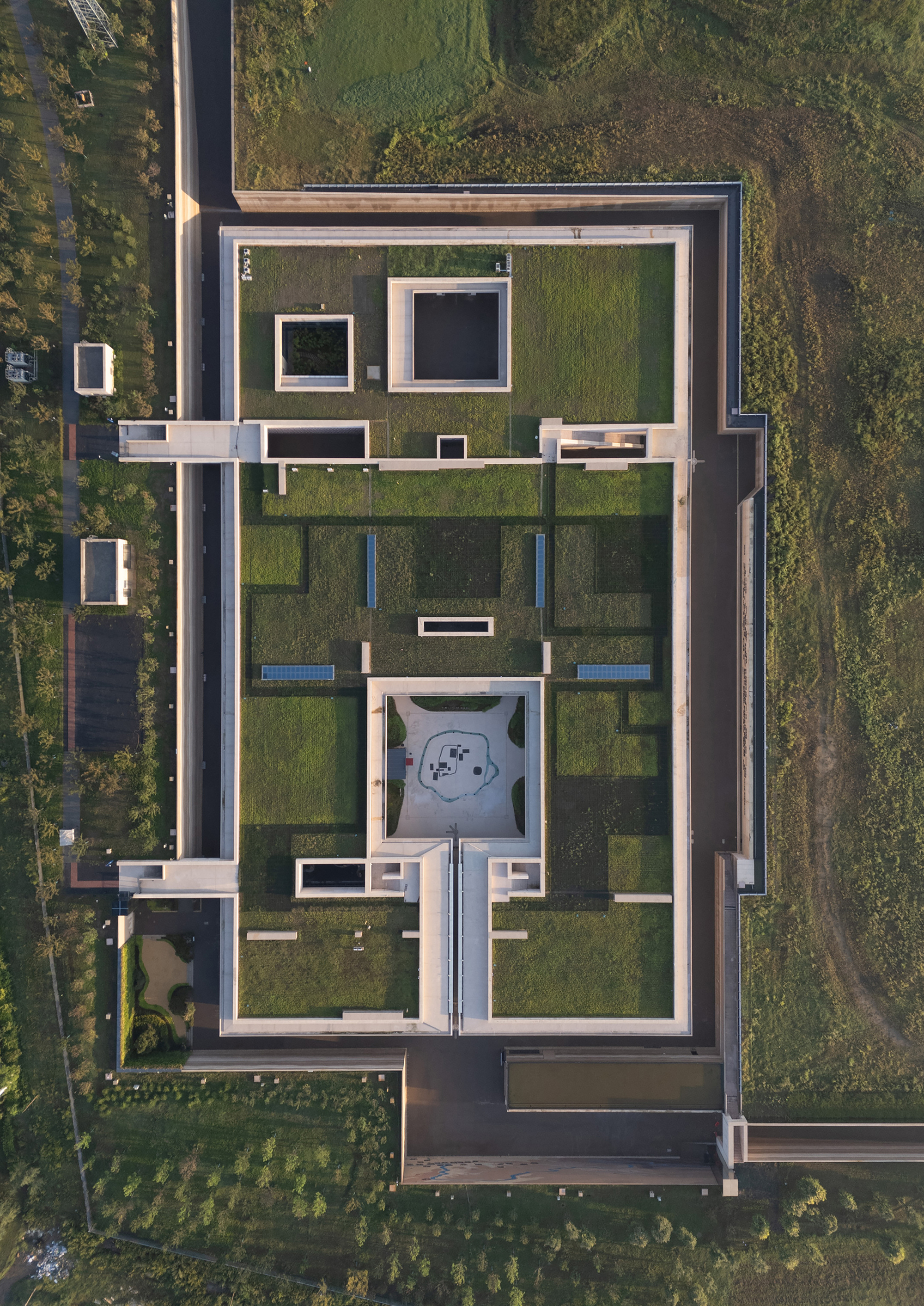 Top-down view showing the gridded layout of courtyards, walls, and water features within the rectangular perimeter