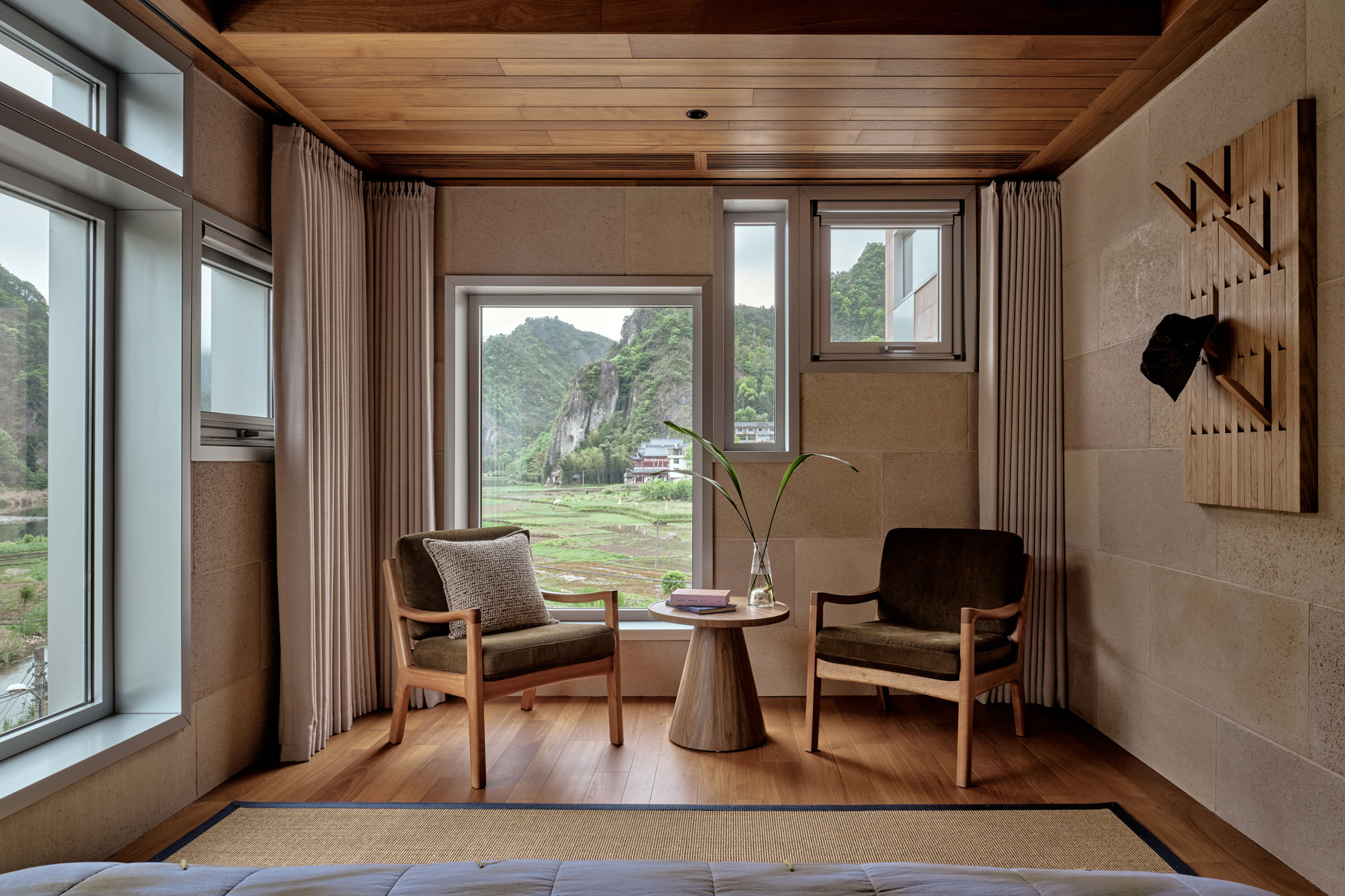 Corner seating nook with timber flooring and multiple windows looking toward the valley landscape